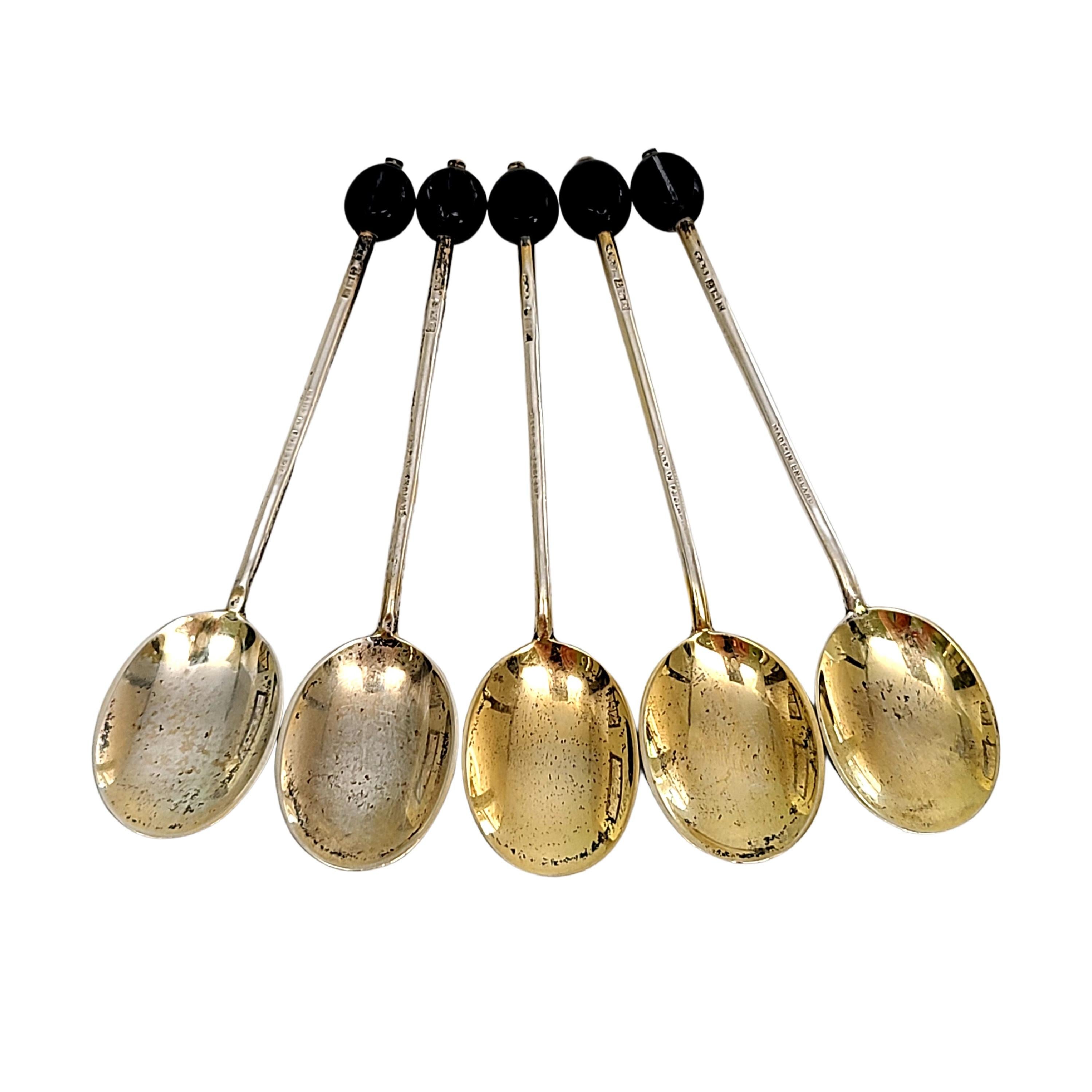 Set of 5 sterling silver and enamel demitasse spoons by Turner & Simpson of Birmingham, England, circa 1960's.

No monogram

Beautifully enameled in a different flower design on the back of each bowl. Espresso bean tops each handle. Spoon bowls have