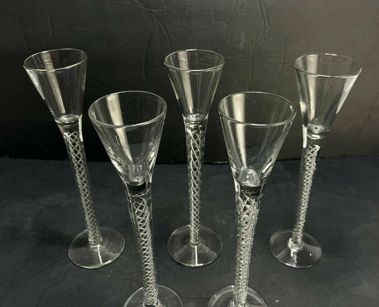 5 Victorian English glass wine goblets, air twist stems, 2nd half 19th century

Airtwist to the stems. Each with rough pontils to the underside.

Additional information:
Lid Type: Twist 
Time Period Manufactured: 1850-1899
Material: Glass