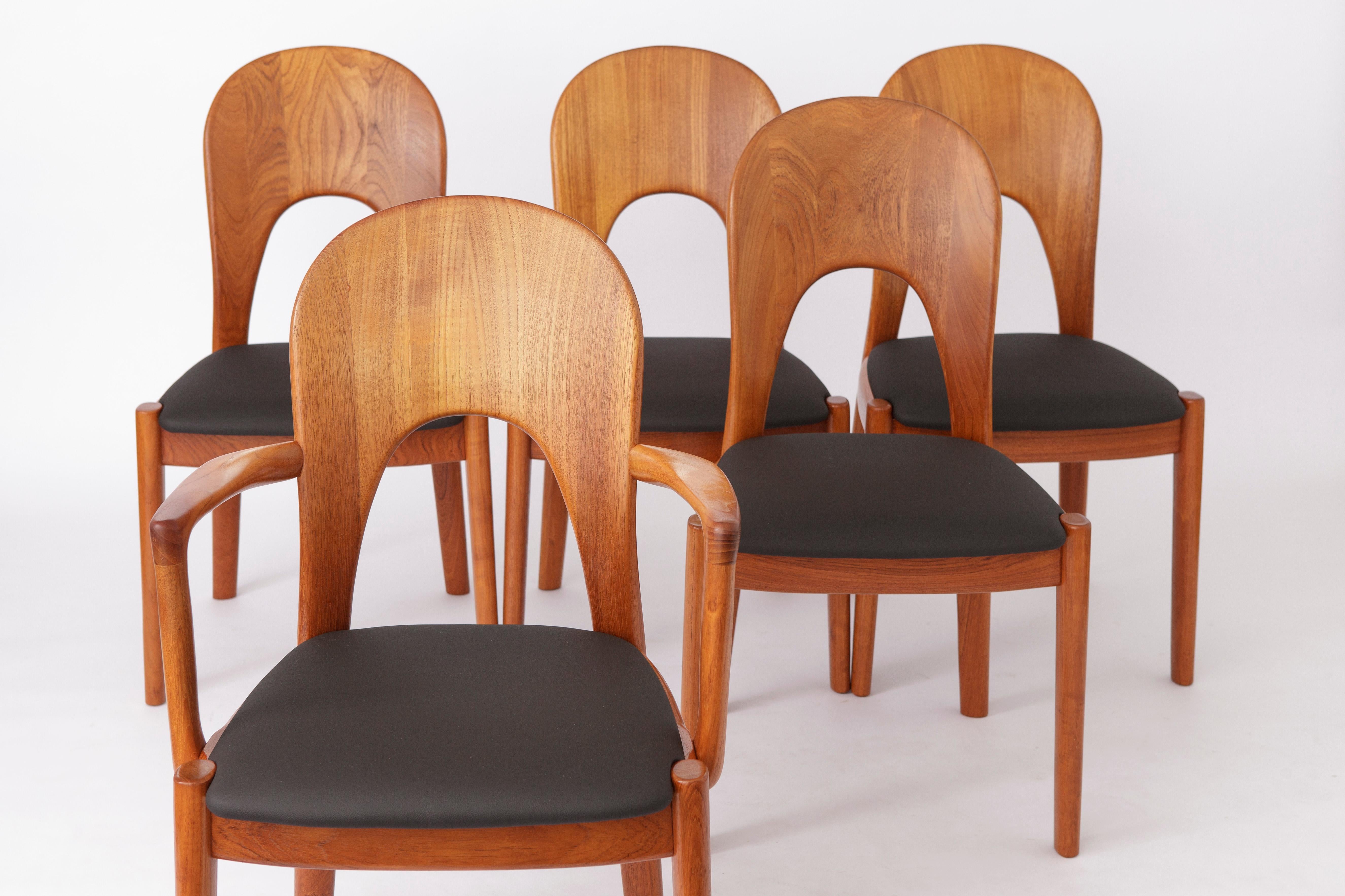 Vintage chairs from Danish designer Niels Koefoed. 
Displayed price is for a set of 5. 

Good vintage condition. 
Sturdy teak wood frame, refurbished and oiled. 
Seats reupholstered with black artificial leather. 
Can be also redone in black textile