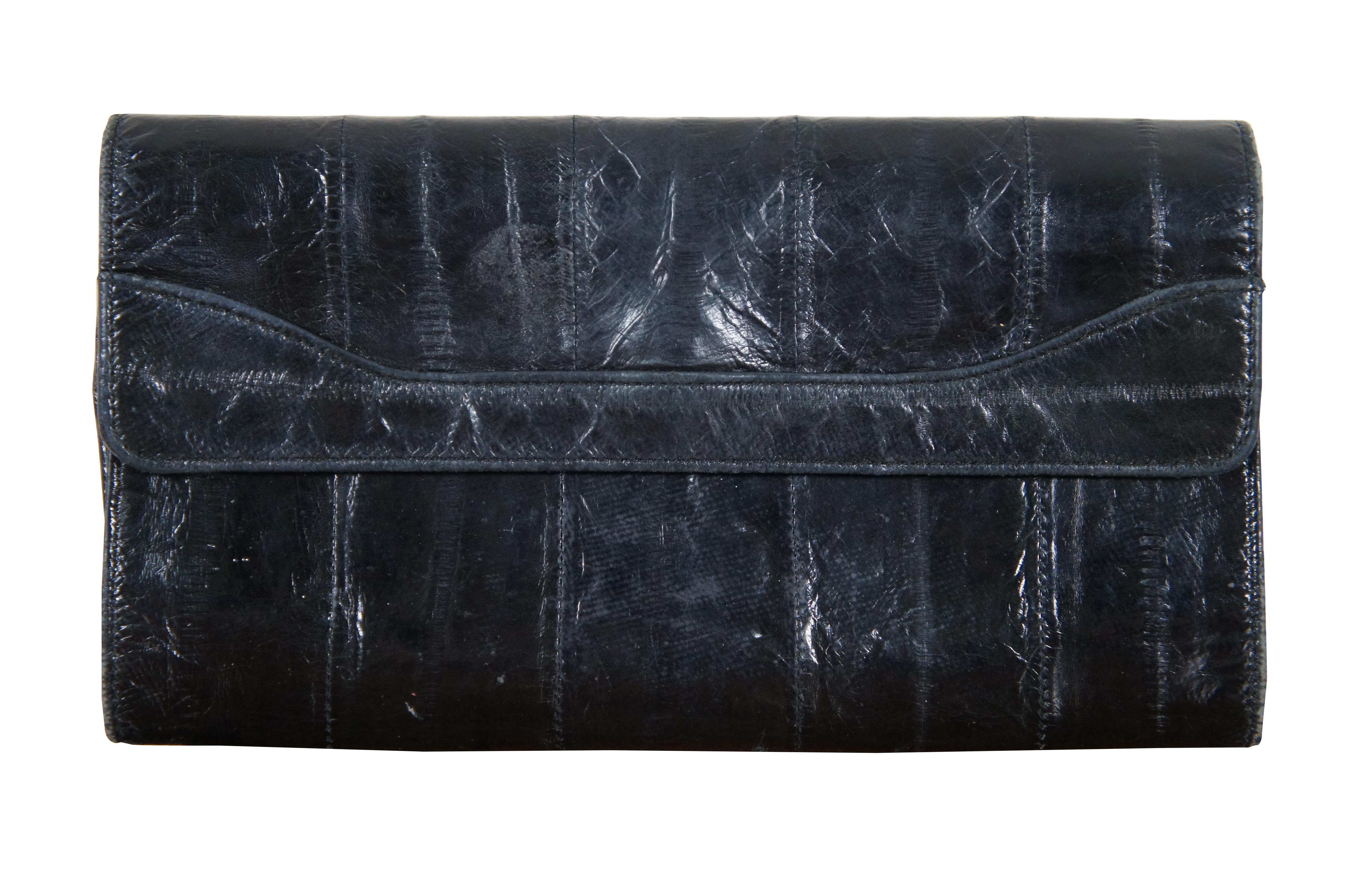 Lot of five vintage eel skin purses including a black tri-fold clutch / billfold, black bi-fold wallet, medium brown wallet, medium brown zippered pouch, and burgundy coin purse / bi-fold wallet.

Largest - 7.5” x 0.75” x 4.125” / Smallest - 3.5”
