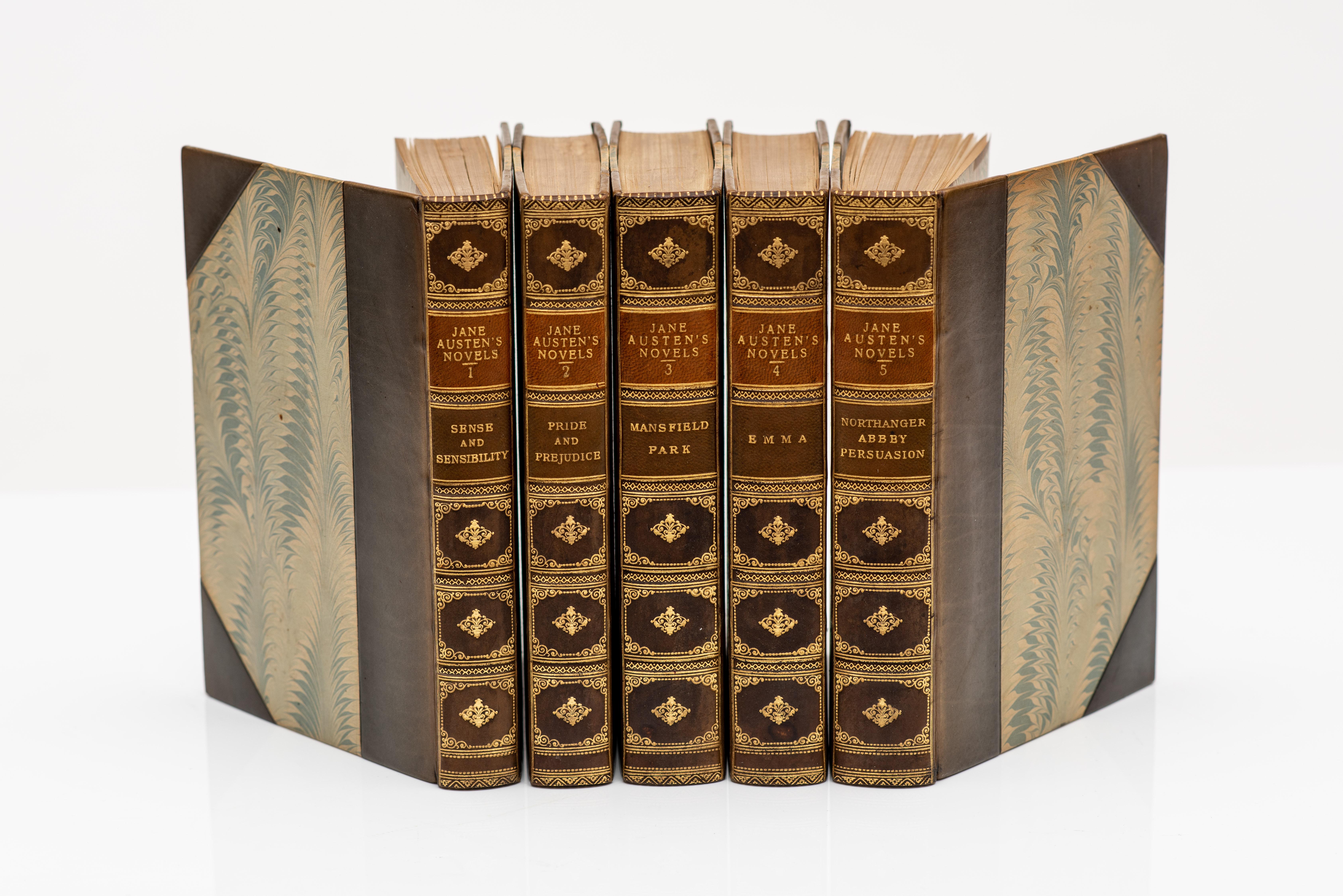5 Volumes. Austen, Jane. Novels. With notes, Indexes & Illustrations from contemporary sources.Bound in 3/4 blue calf by Sawyer, marbled boards, all edges gilt, raised bands, gilt panels, marbled endpapers. Published: Oxford: Clarendon Press, 1946. 