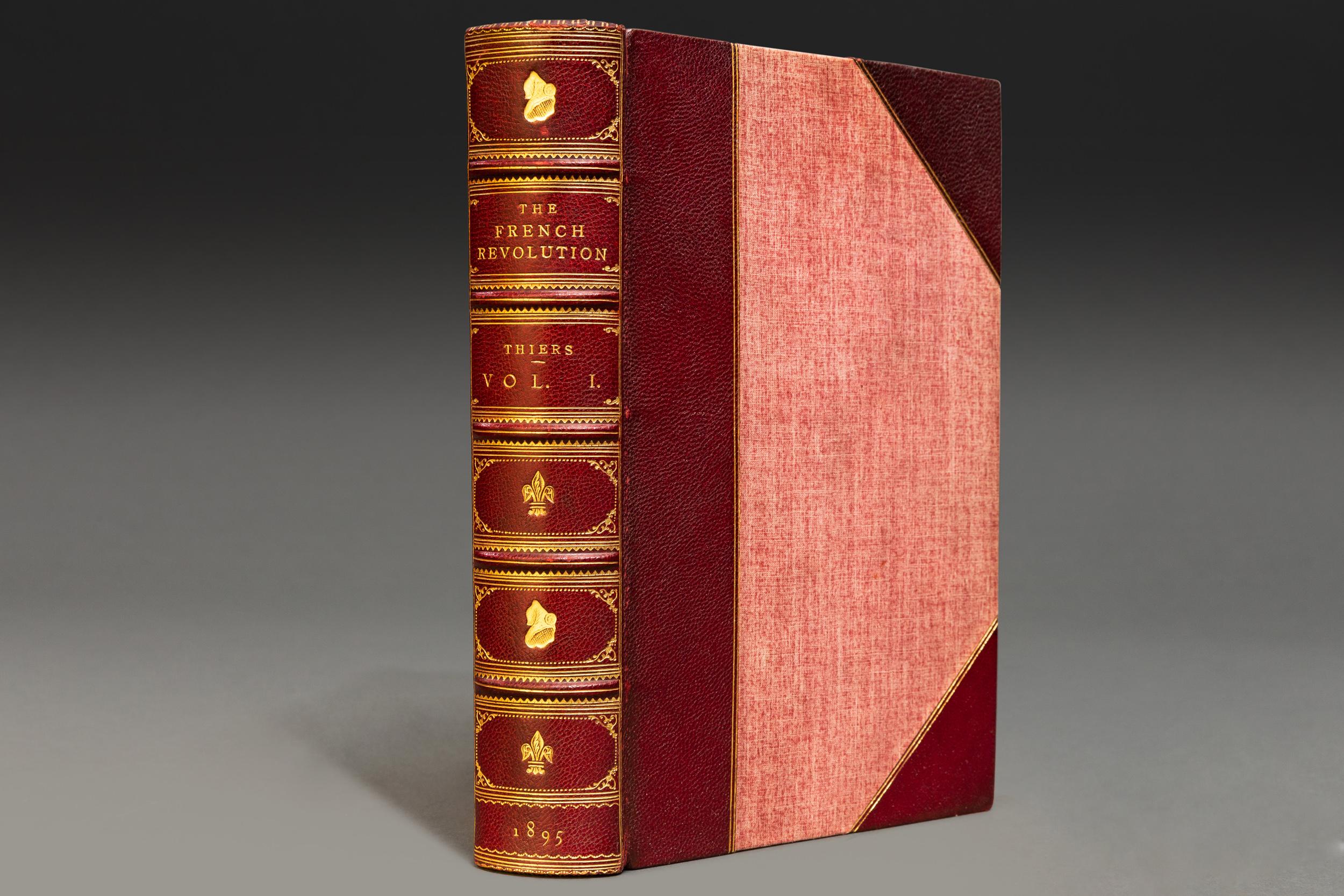 5 volumes. Louis A. Thiers. The History of The French Revolution (1789-1800). Translated with notes & illustrations from the most authentic sources by Frederick Schobert. Bound in 3/4 wine morocco by Morrell linen boards. Marbled endpapers. Raised