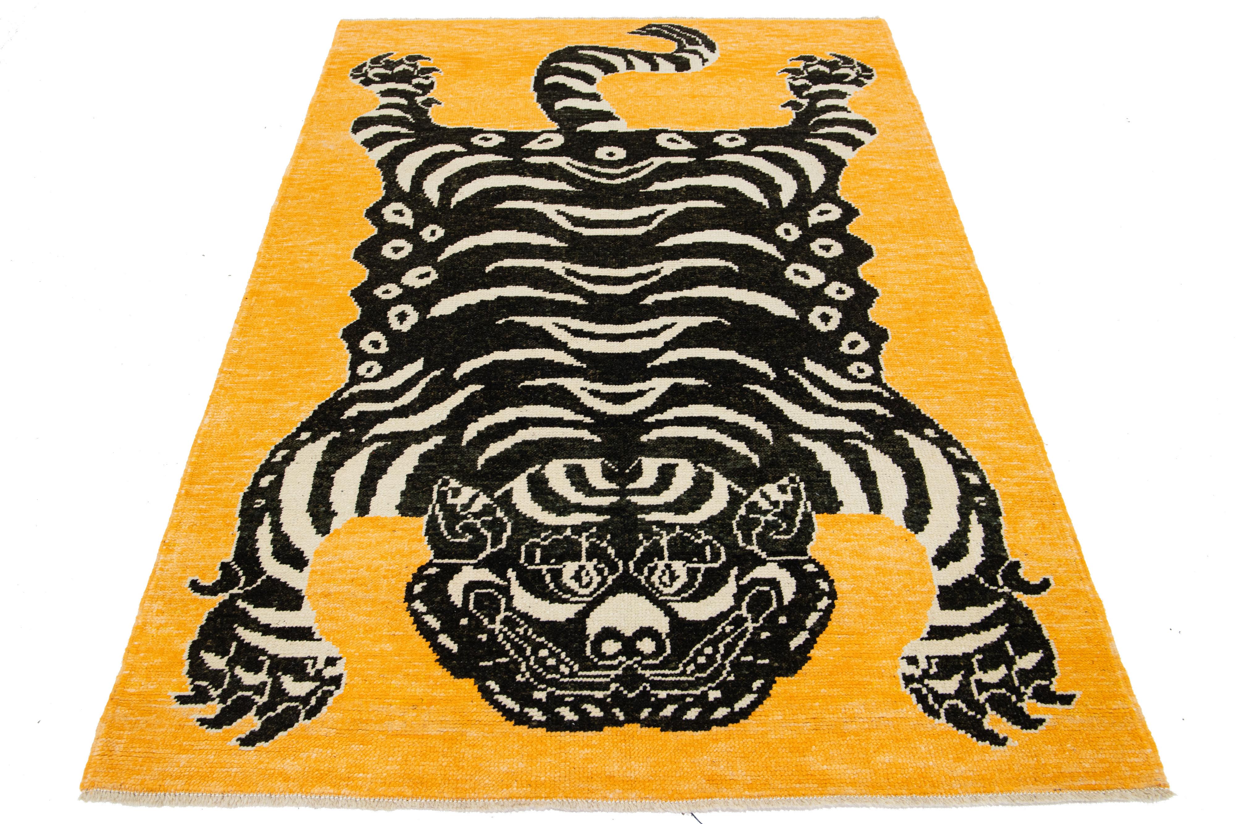 This beautiful Turkish Art Deco wool rug features a goldenrod color field, with accent colors in black and beige, and a stunning tiger pictorial design.

This rug measures 4'9
