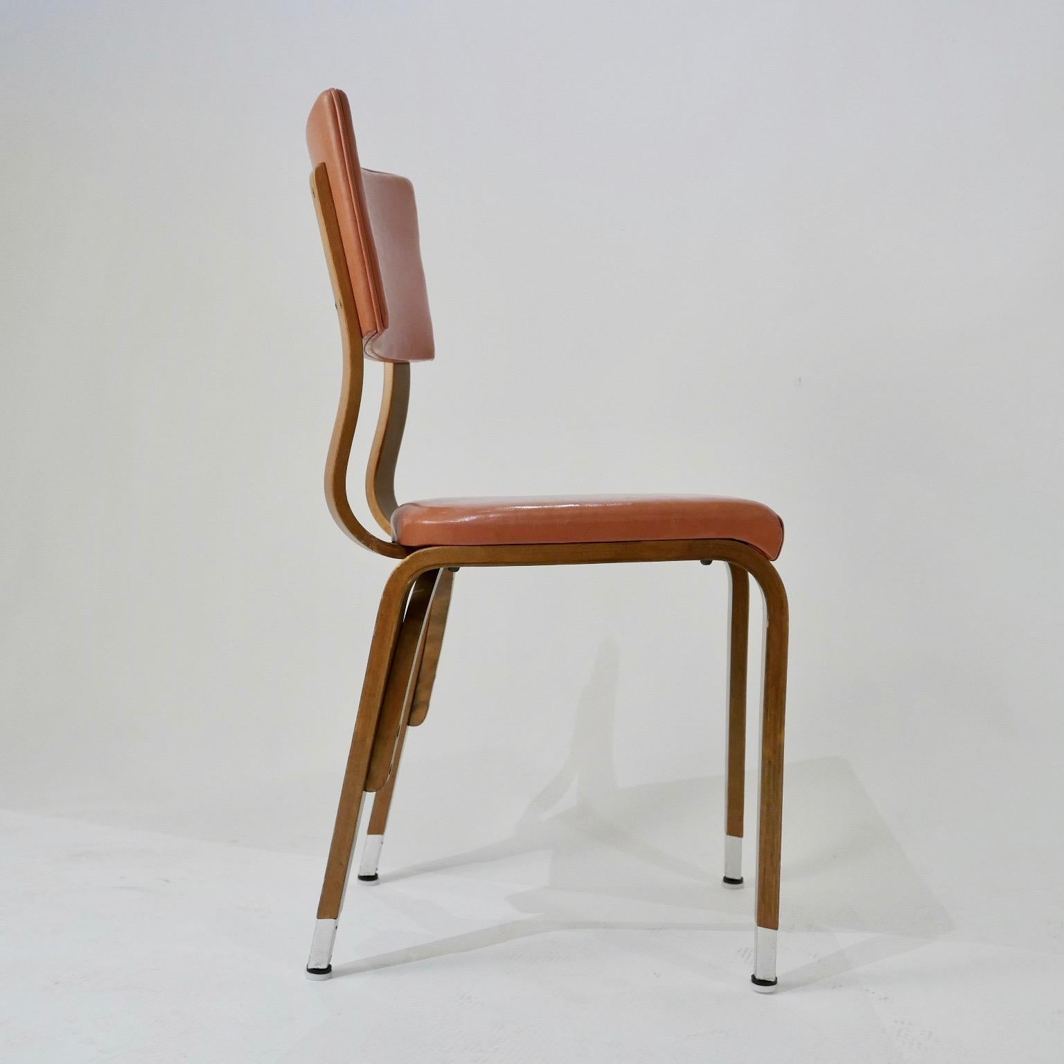 Priced per chair. All chairs are sturdy and in good solid condition. These chairs would be great for a restaurant or cafe'. Solid bent plywood frames with a light terracotta colored seat and back. Very usable and versatile Classic design that would