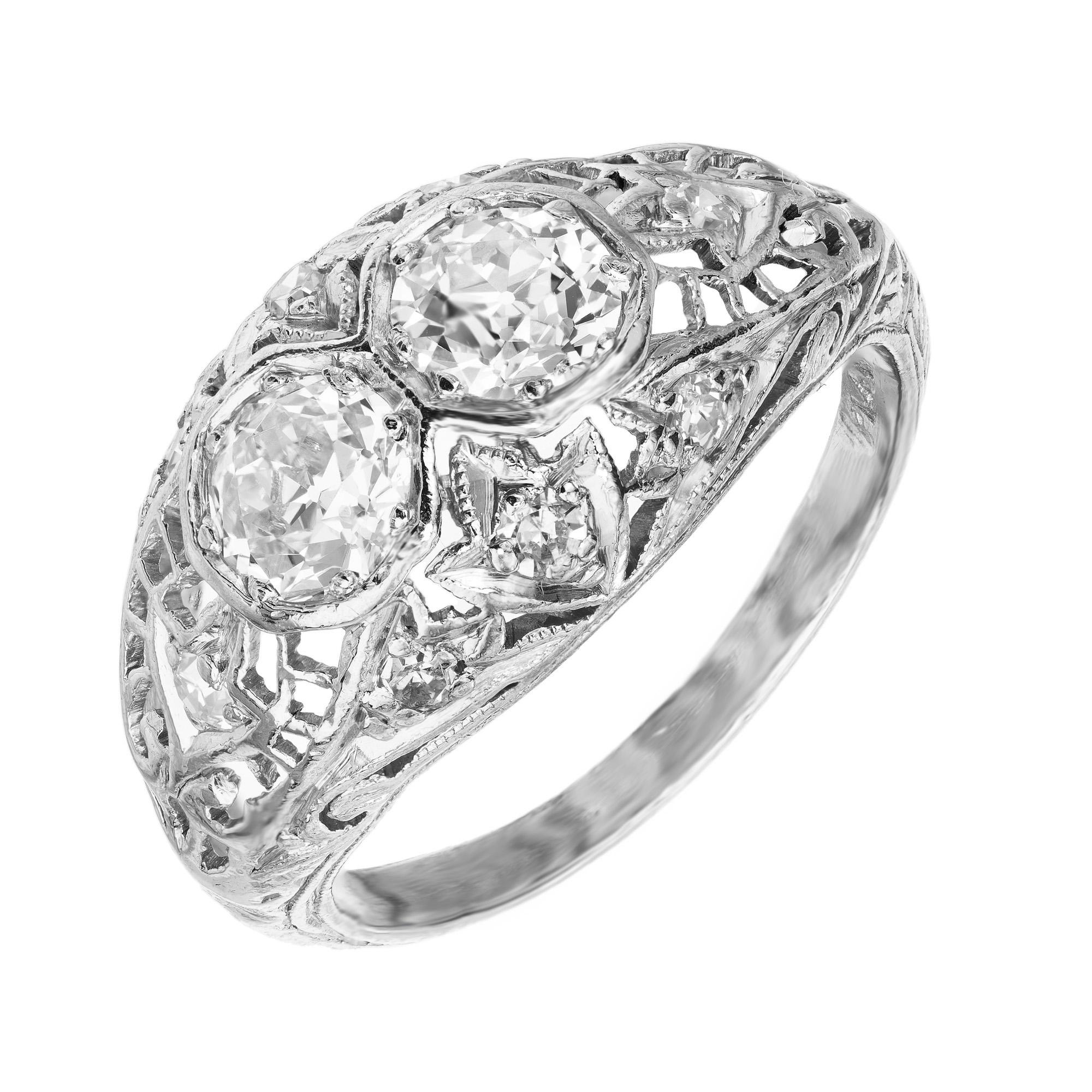 Two stone diamond dome engagement ring. Set with 2 Old European shape diamonds with a total weight of .50cts. This Platinum filigree setting is also enriched with 8 single cut diamonds set throughout the ring. The mounting is hand pierced with