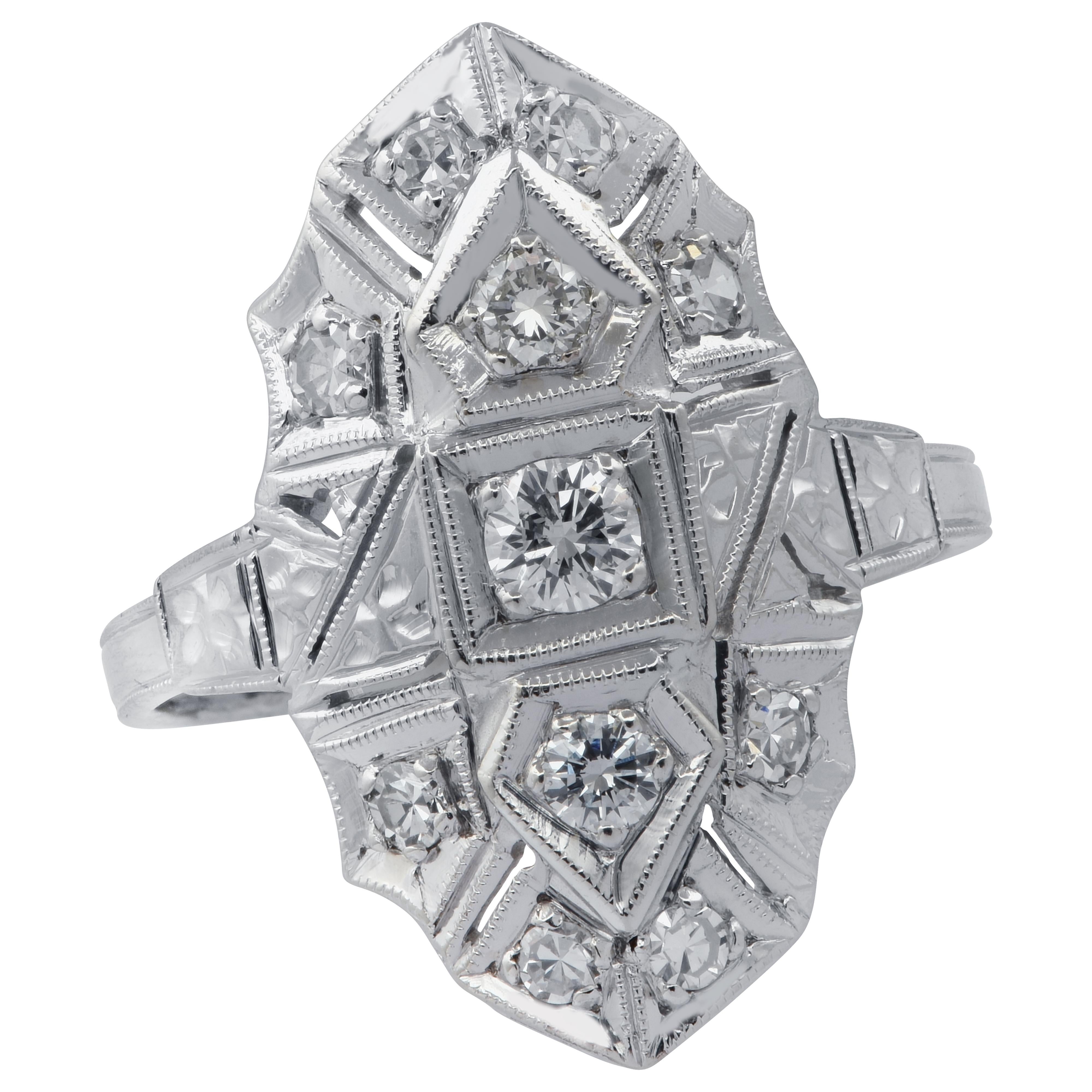 Art deco style shield ring crafted in 14 karat white featuring 11 single and round brilliant cut diamonds weighing approximately .50 carats total, G color, VS clarity.  This fabulous ring measures 22.7mm at the widest point and gently tapering down