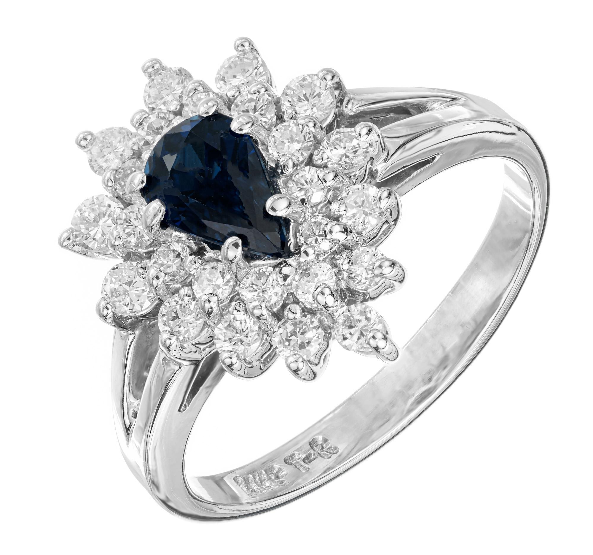 Blue sapphire and diamond engagement ring. Pear shaped .50ct sapphire center stone, with a two row halo of 25 round cut diamonds in a 14k white gold setting.

1 pear shaped greenish blue sapphire, approx. .50cts
12 round diamond, I-J SI approx.