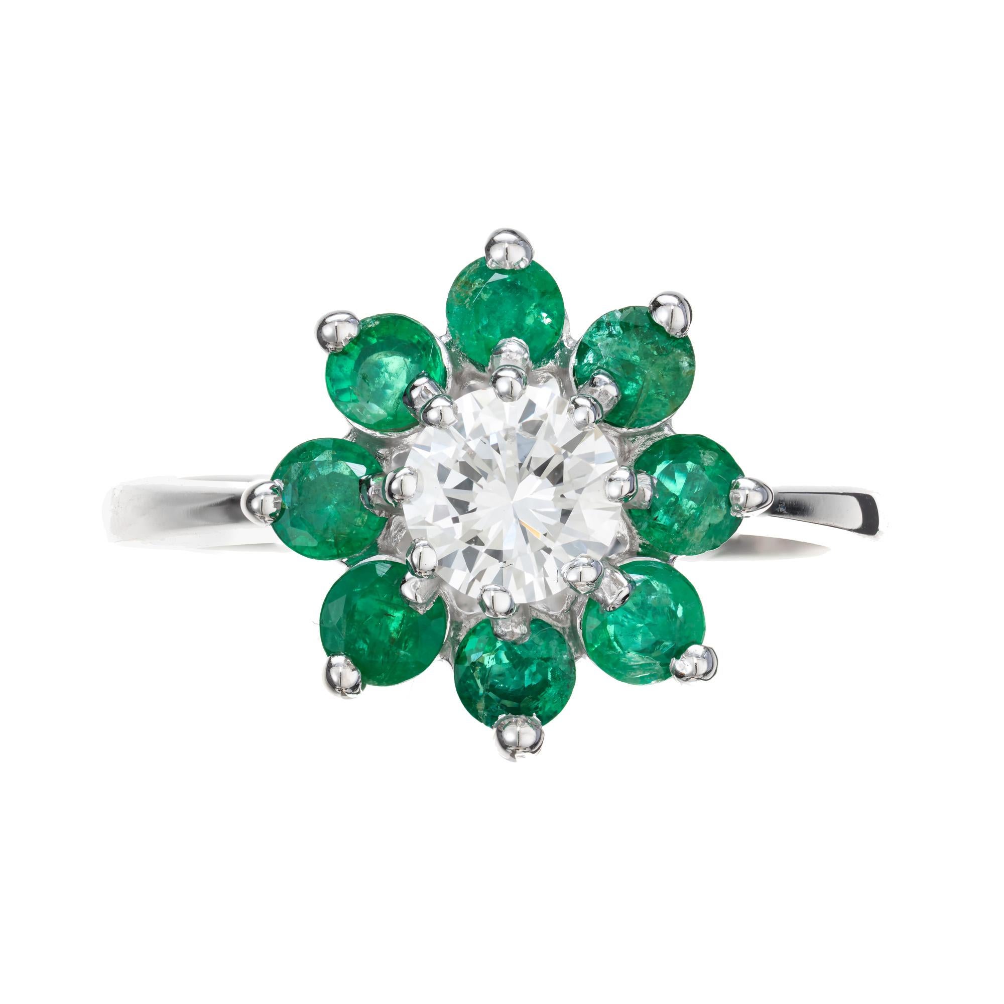 Mid-Century 1960's diamond and emerald engagement ring. .50ct round brilliant cut center diamond with a halo of 8 round green emeralds in a 14k white gold setting. 

Follow us on our 1stdibs storefront to view our weekly new additions and 5 Star
