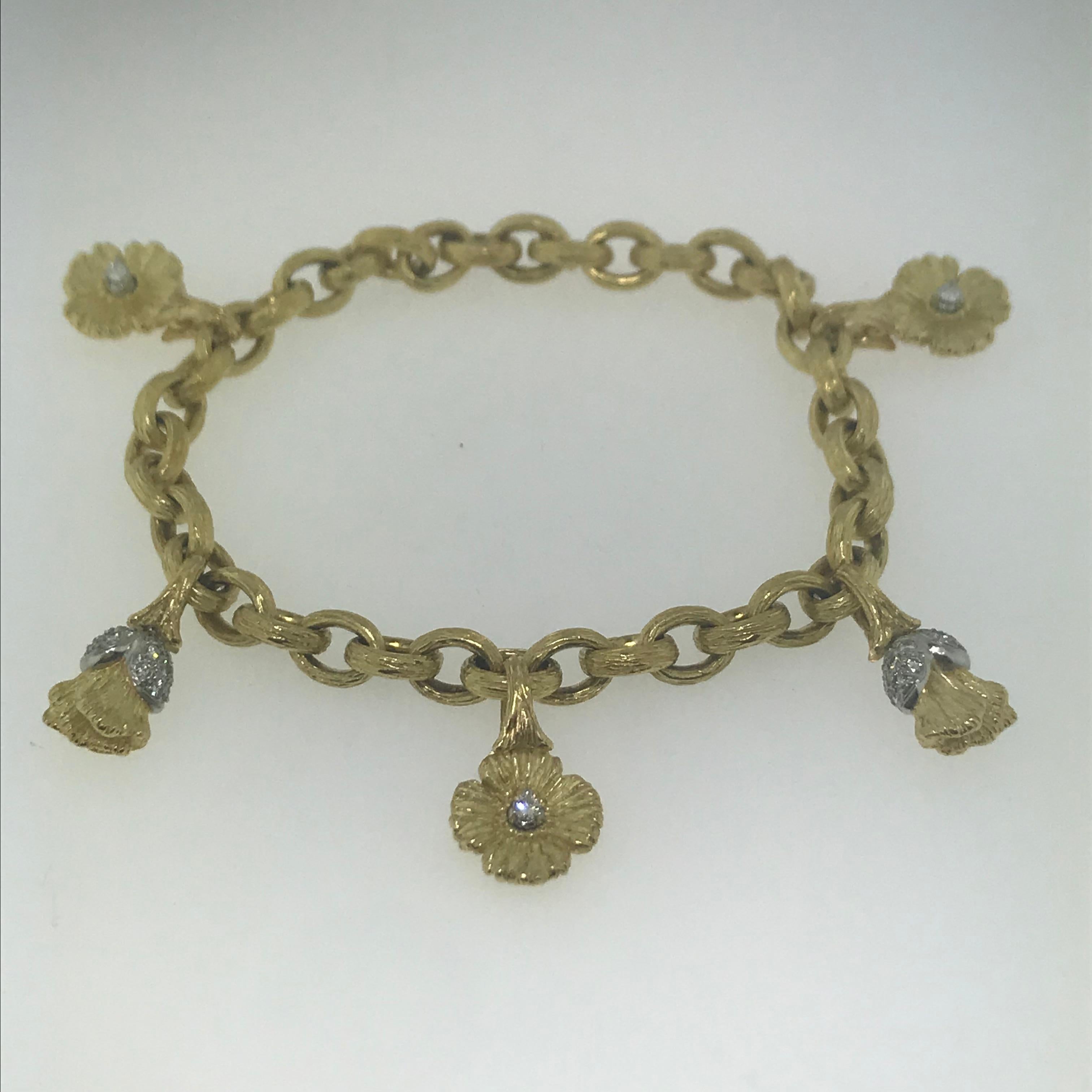 Diamond Flower Charm Bracelet in 18 karat Yellow Gold with 1/2 carat of diamonds (.50 carats).  These piece has the feel of a famous designer and the color of the gold and platinum is very rich and heavy.
Full of grace and importance is the owner of