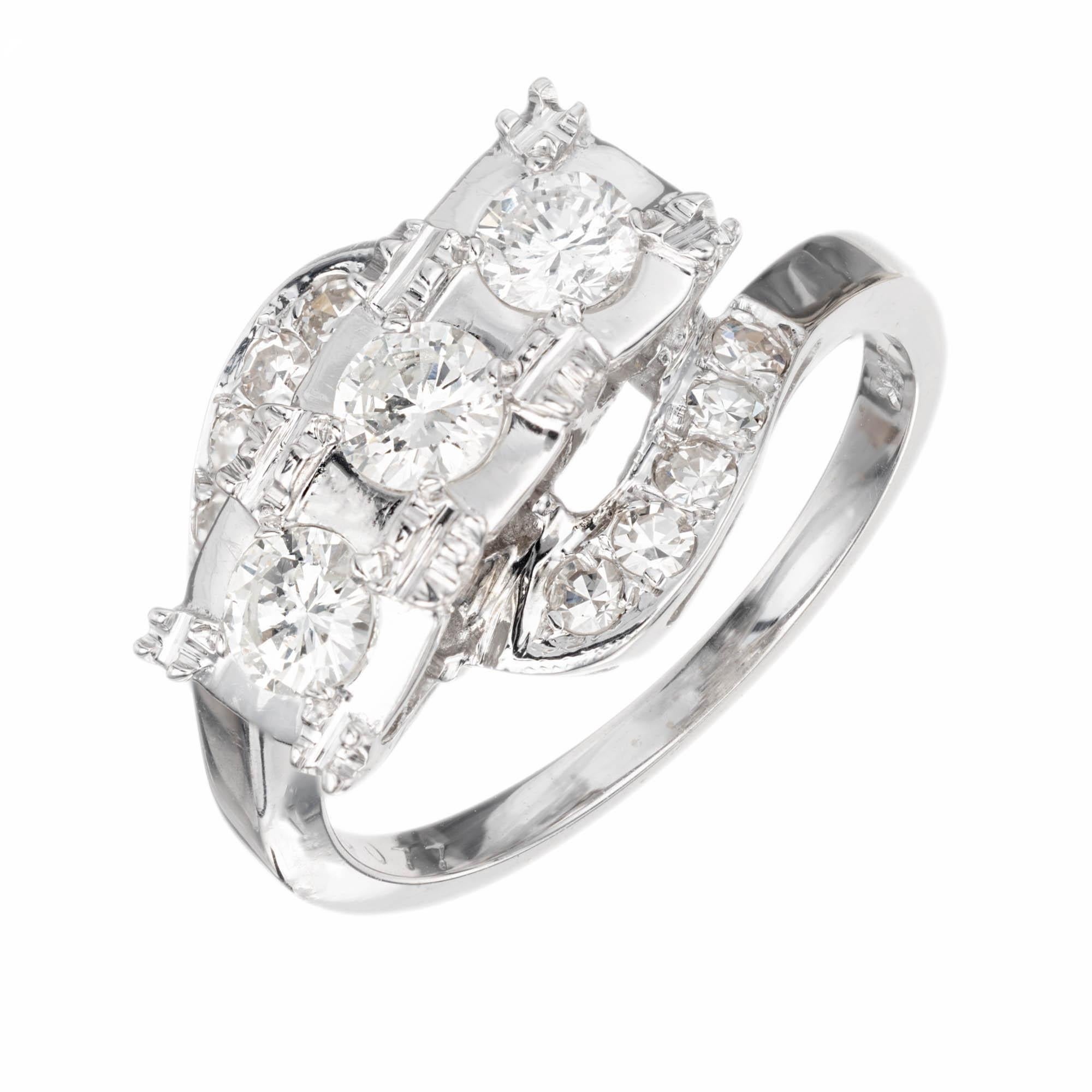 Vintage 1950s three stone diamond ring. Swirl bypass style in 14k white gold. Three center diamonds, accented with single cut dimamonds.

3 round brilliant cut J SI diamonds, Approx. .50 carats
10 single cut S-K VS-SI diamonds, Approx.