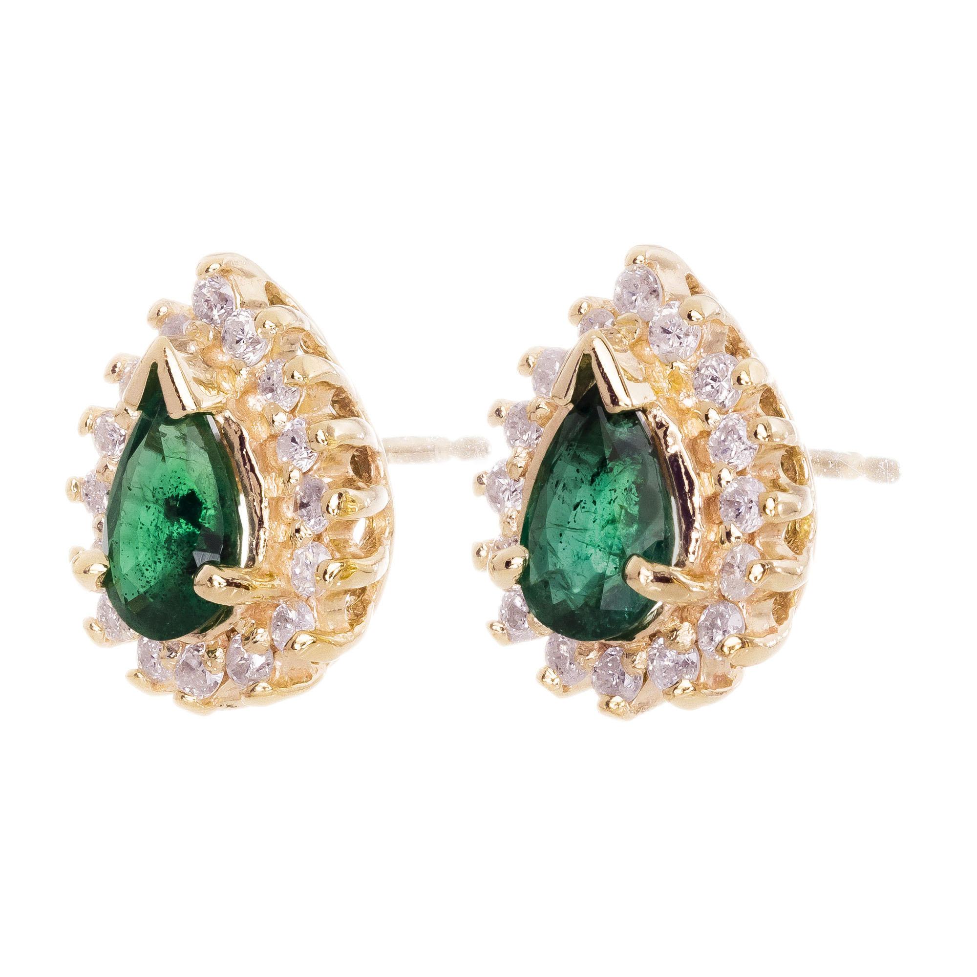 Green genuine pear shape emerald earrings with round brilliant cut diamond halo's, set in 14k yellow gold settings. 

2 pear shaped deep green emeralds, I approx. .50cts
32 round brilliant cut diamonds, G-H SI approx. .25cts
14k yellow gold