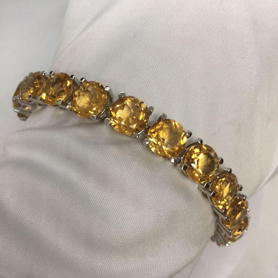 

50 Carat Natural Citrine Lady's Tennis Bracelet Sterling Silver 10 mm 
7.5 Inch
27.8 gram
Natural Citrine all approximately 10 mm round  by 6 mm deep, calculated to be 2.80 Carat each, total of 50 Carat 
In good condition, no evidence of repair,