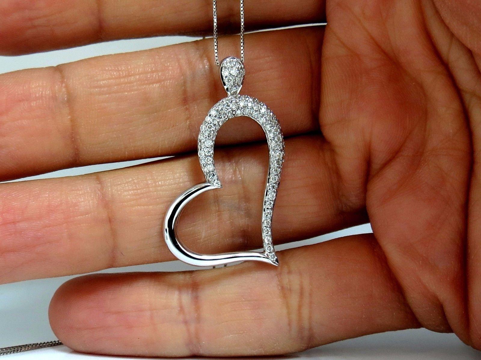 Wide Slanted Heart Diamonds Necklace.

Intricate pave set diamonds.

.50ct. Natural Diamonds

Round, Brilliant full cuts:

G color VS-2 clarity.

14Kt White gold 

pendant measures: 1.3 Inch X .79 Inch.


Necklace: 18 Inches.
Grand weight: 4.2 Grams.