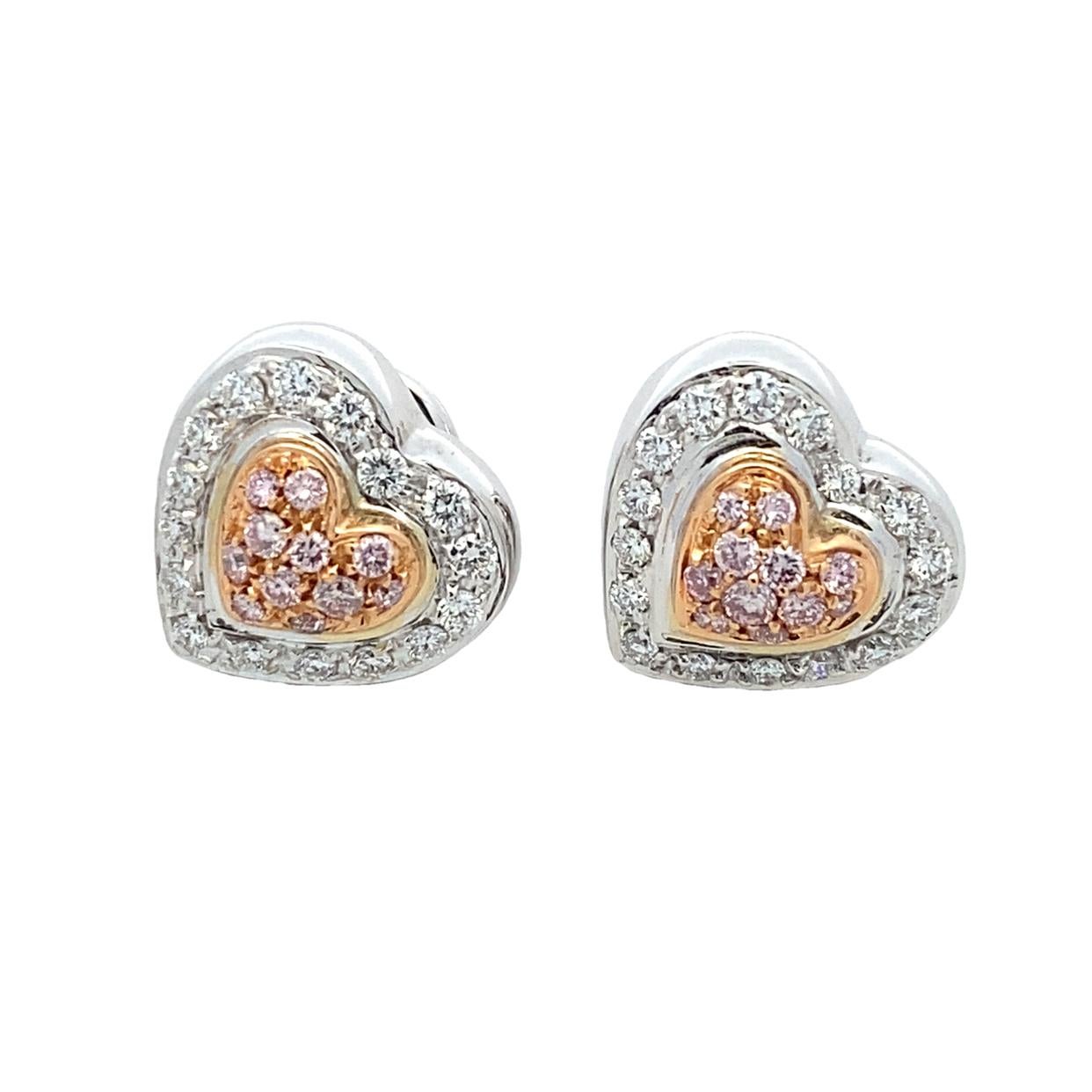 Beautifully crafted double heart shape diamond earrings featuring natural fancy pink and white diamonds. 

Made in 1990s, these are push back earrings that feature two-tone 18 karat gold, the perfect blend of white and rose gold.

Earring