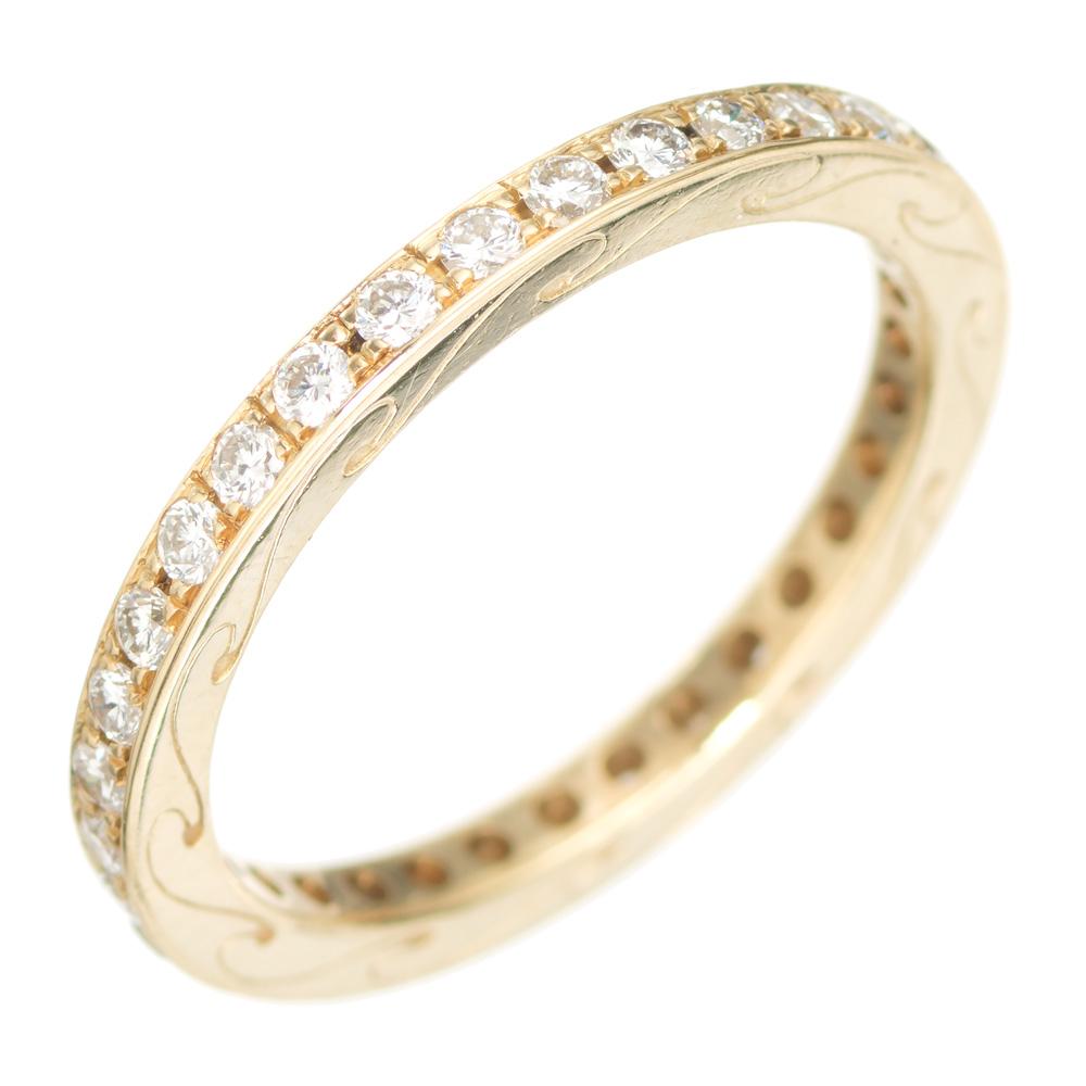 Diamond wedding band. 33 round cut diamonds set in a 18k yellow gold eternity setting with swirl engraving on both sides. 

33 round cut diamonds, approx. total weight. .50cts VS, G
Size: 6.25 not sizable
Tested: 18k yellow gold
Weight: 2.4 grams

