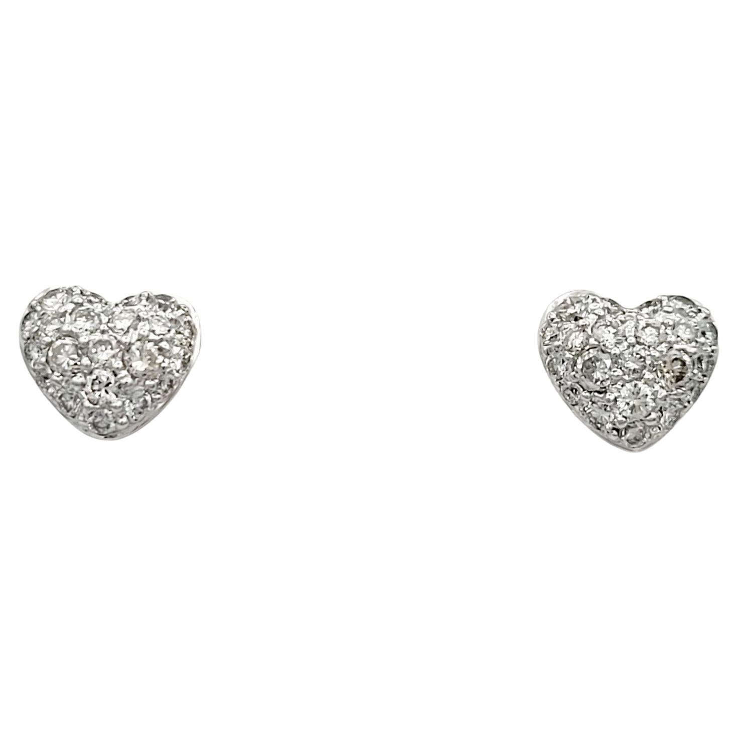 These pavé diamond heart stud earrings, set in exquisite 18 karat white gold, are a symbol of timeless romance and elegance. Each earring features a delicate heart shape adorned with pavé-set diamonds, creating a dazzling and brilliant surface that