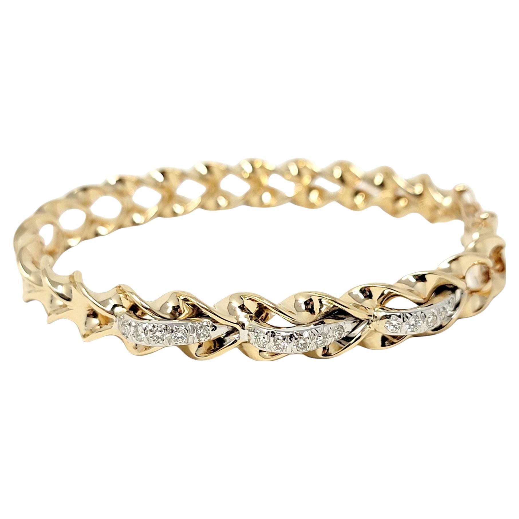 Uniquely designed contemporary bangle bracelet with sleek diamond wave design. This beautiful bracelet is made of polished 14 karat yellow gold and features a hinged side opening. The top half of the bracelet has a modern wave design and is set with