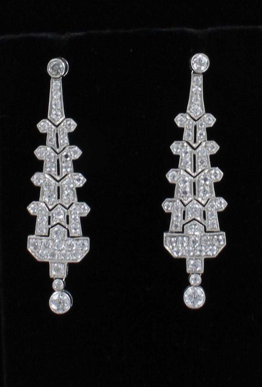 These charismatic drops are dressed in 5.0 carat total weight of diamonds for an effect that's truly glamorous. The top diamond and the bottom diamond are bezel-set and the rest of the magnificent design is laden with pave-set diamonds. This