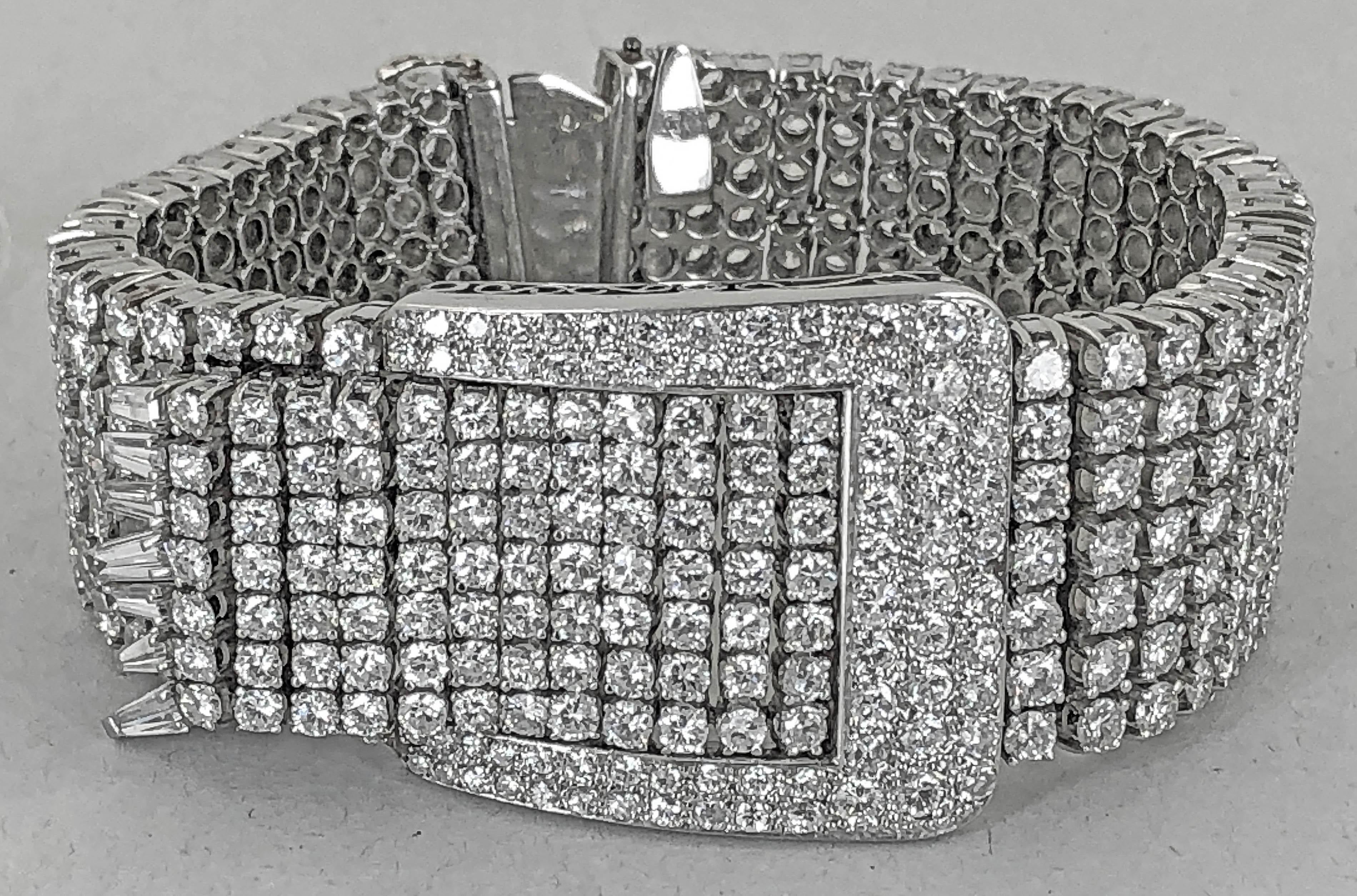 Comprising a platinum bracelet from the 1960s, adorned with the opulence of round-cut diamonds weighing approximately 50 carats placed together to form a buckle motif.  The bracelet measures approximately 7 1/4 inches in length and 1 1/4 inches in