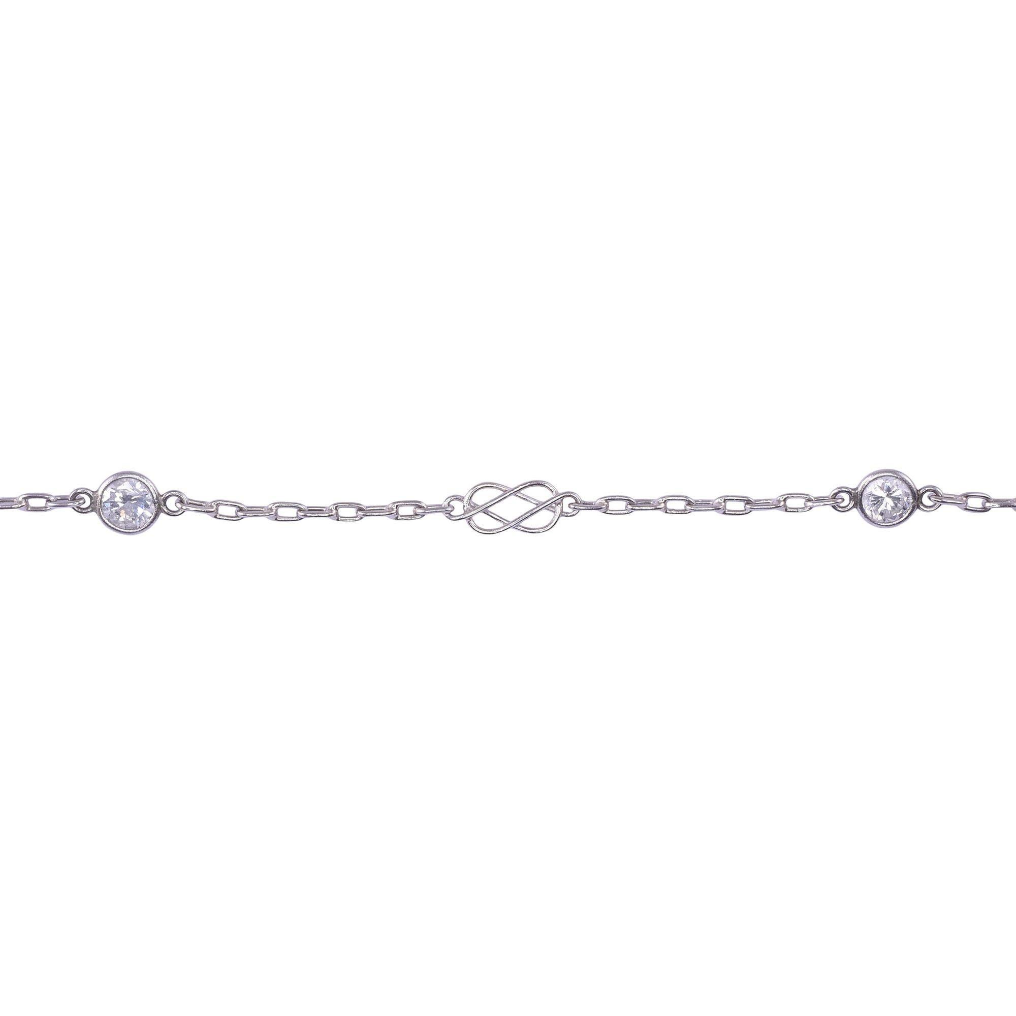 Antique 50 inch diamond platinum chain necklace, circa 1920. This hand made platinum chain features 30 bezel set round brilliant cut diamonds from 2.7-2.8mm. The diamond have VS2-I1 clarity and I-J color. There are also decorative links in between