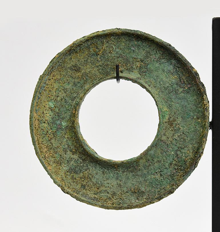 A pair of Dong Son bronze bangles with very nice green patina with stand.

Age: Cambodia, Dong Son Period, 500 B.C.
Size of bangle: Diameter 9.6 - 9.7 C.M. / Thickness 0.8 C.M.
Size including stand: Height 28 C.M.
Condition: Nice condition overall