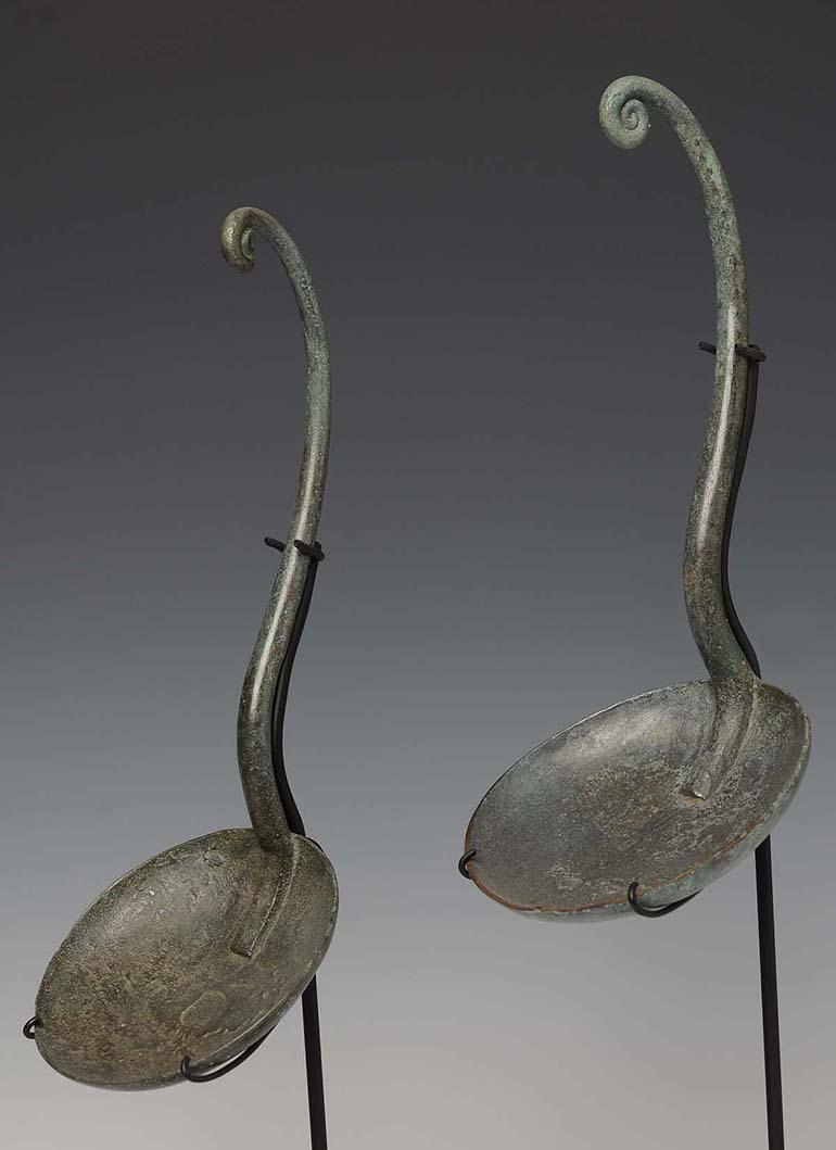 A pair of Dong Son bronze ladles with nice patina.

Age: Cambodia, Dong Son Period, 500 B.C.
Size: Length 24.4 - 25.5 C.M. / Width 9.7 - 10.8 C.M. (size excluding stand)
Condition: Nice condition overall (some expected degradation due to their