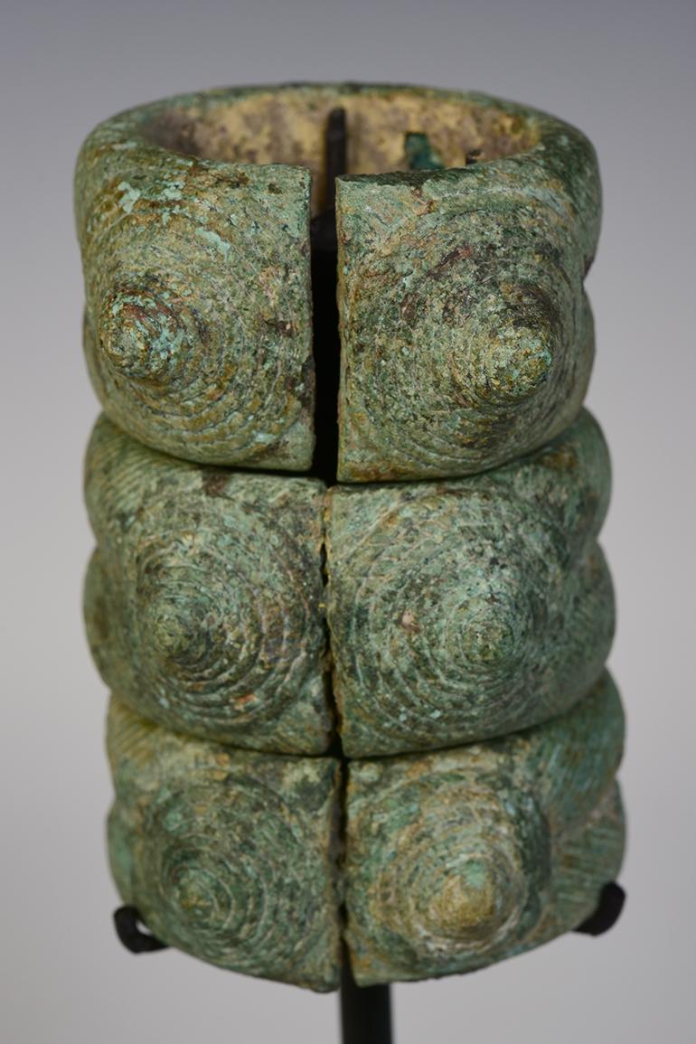 A set of Dong Son bronze bracelets with very nice green patina.

Age: Cambodia, Dong Son Period, 500 B.C.
Size: Height 9 C.M. / Width 6 C.M. (size excluding stand)
Condition: Nice condition overall (some expected degradation due to their age).