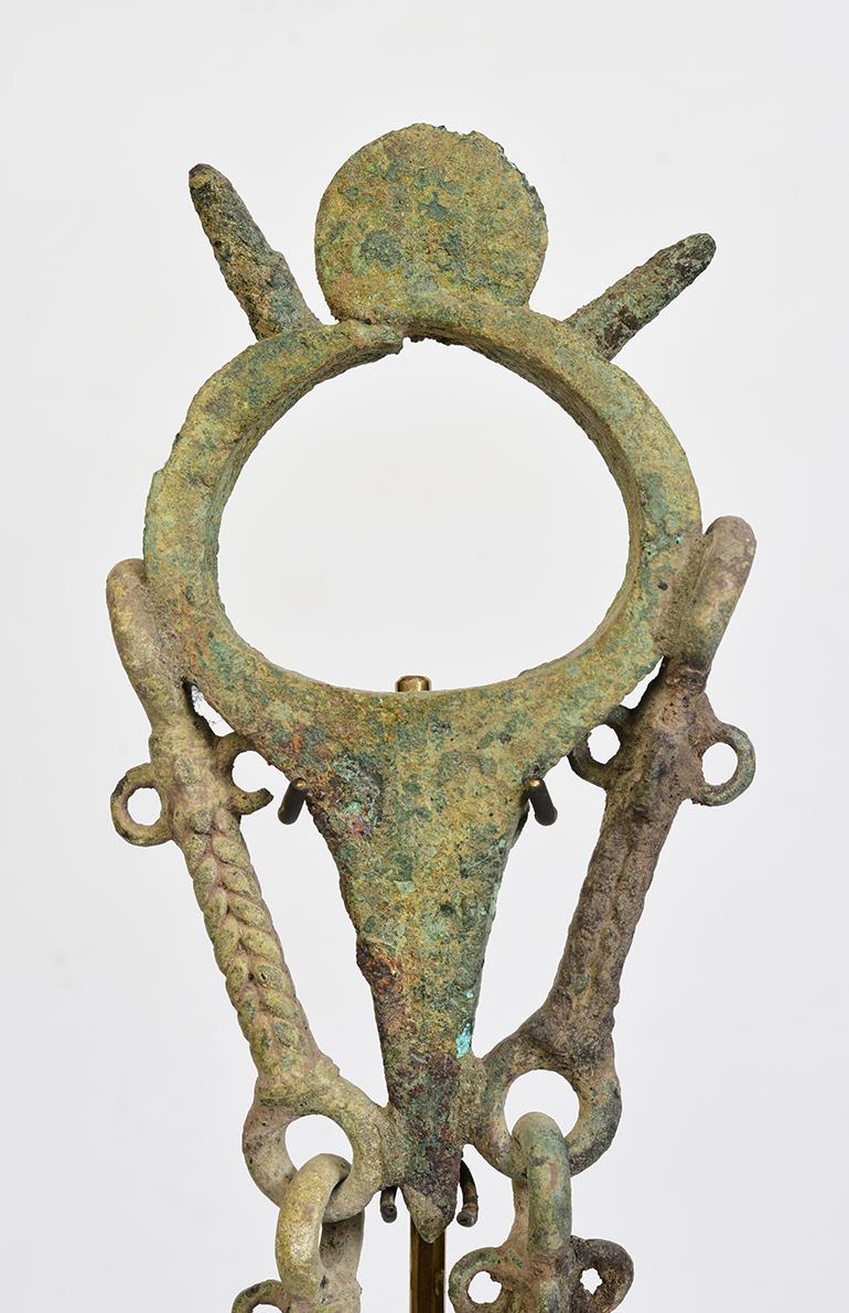 Dong Son bronze bracelet with bell, very nice green patina.

Age: Cambodia, Dong Son Period, 500 B.C.
Size: width 8 cm / length 43.4 cm.
Size including stand: height 49.5 cm.
Condition: Nice condition overall (some expected degradation due to