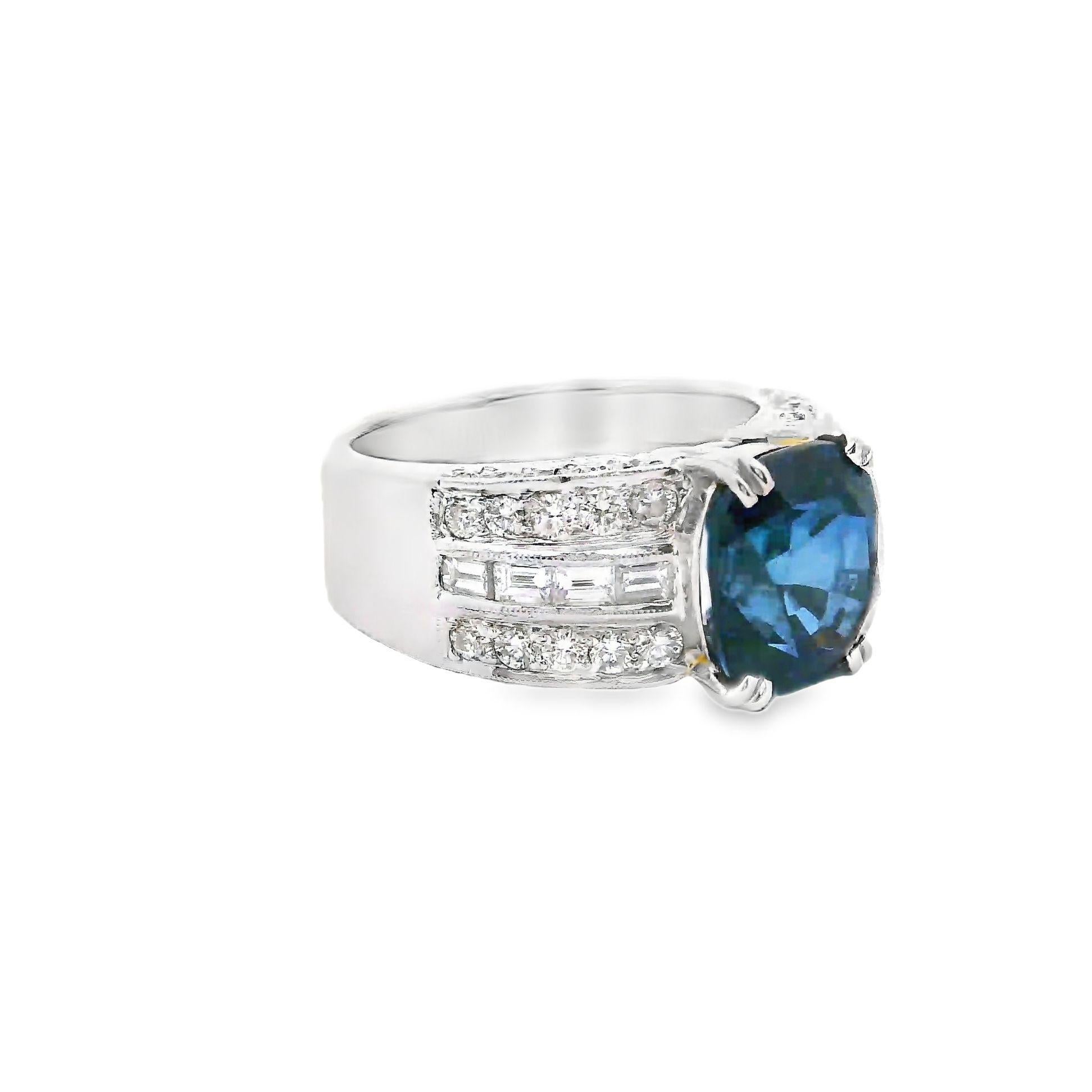A lovely platinum ring featuring a fine 5.00 carat cushion-shape blue sapphire. It has a rich and vibrant blue color that scintillates in the light. It is certified by the GIA as natural and coming from Madagascar. It is complemented by 1.01 carats