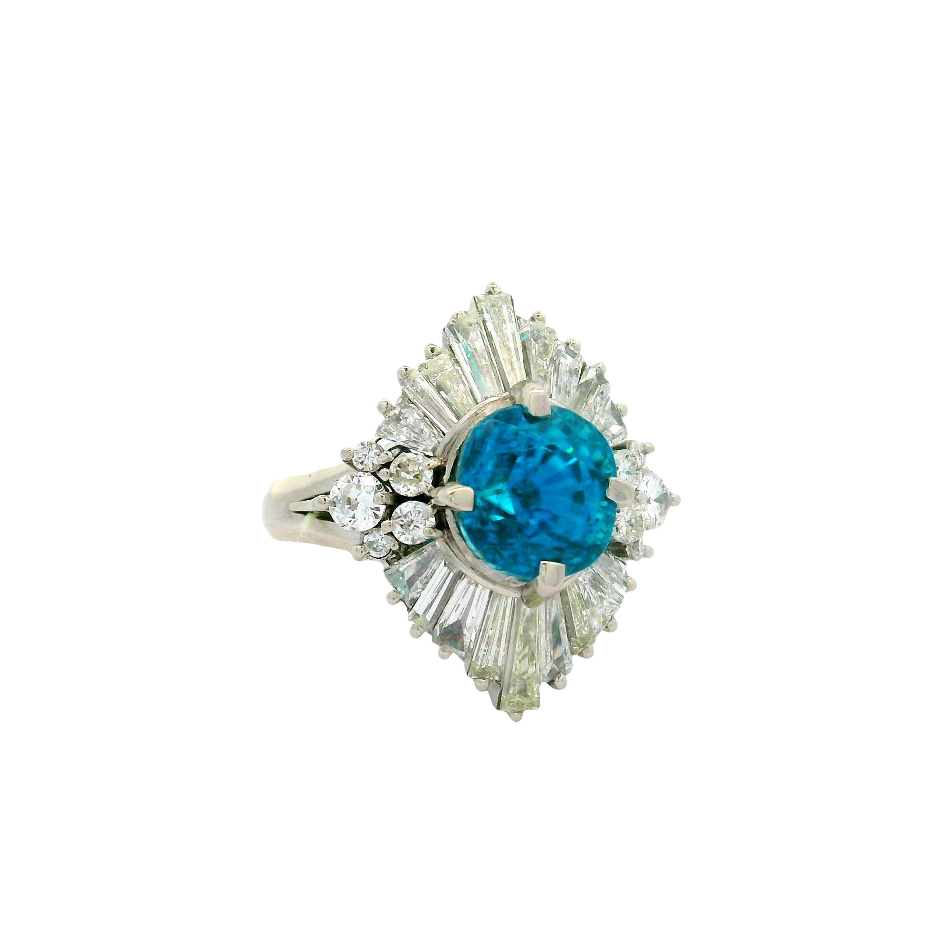 A contemporary fashion ring featuring a striking 5.0 carat oval-cut blue zircon as its centerpiece. The stone radiates a vivid blue hue, capturing attention with its brilliance. Surrounding the zircon are 1.48 carats of mixed-cut white diamonds,