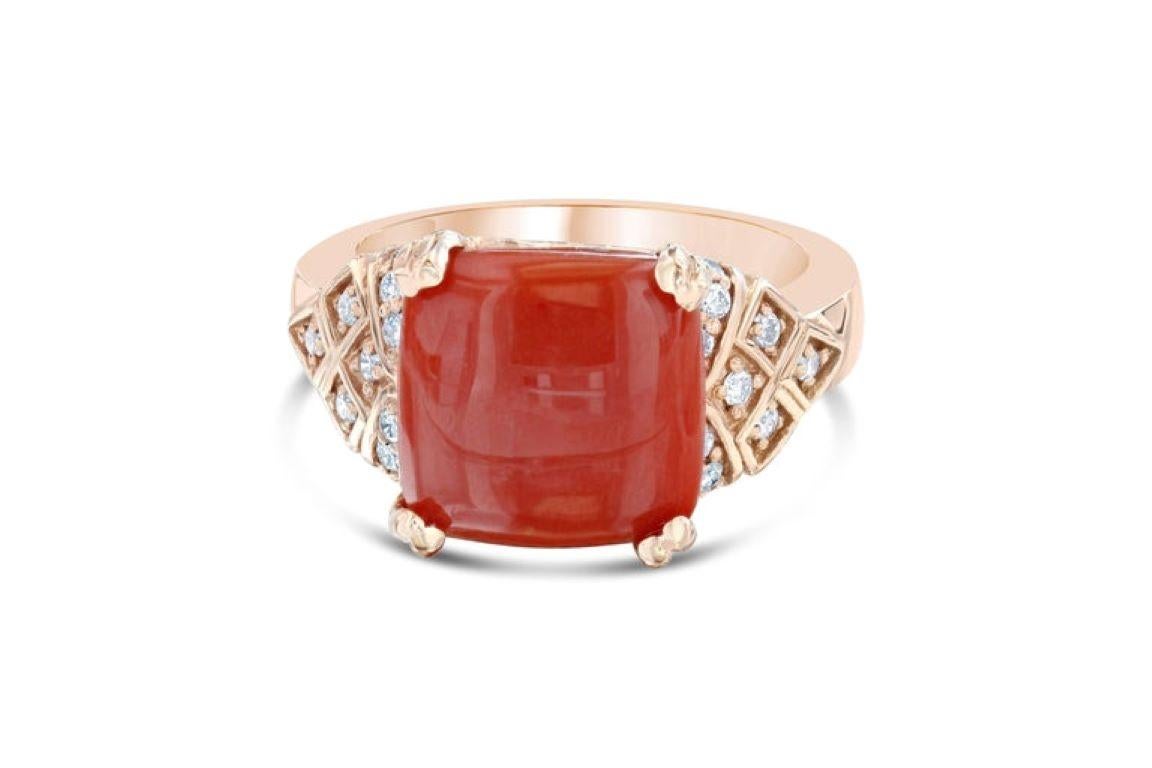 This ring has a 4.39 Carat Cushion Cabochon Coral that measures at 11 mm x 11 mm. It is further embellished with 36 Round Cut Diamonds that weigh 0.61 Carats.  The total carat weight of the ring is 5.00 carats.

The ring is made in 14K Rose Gold and