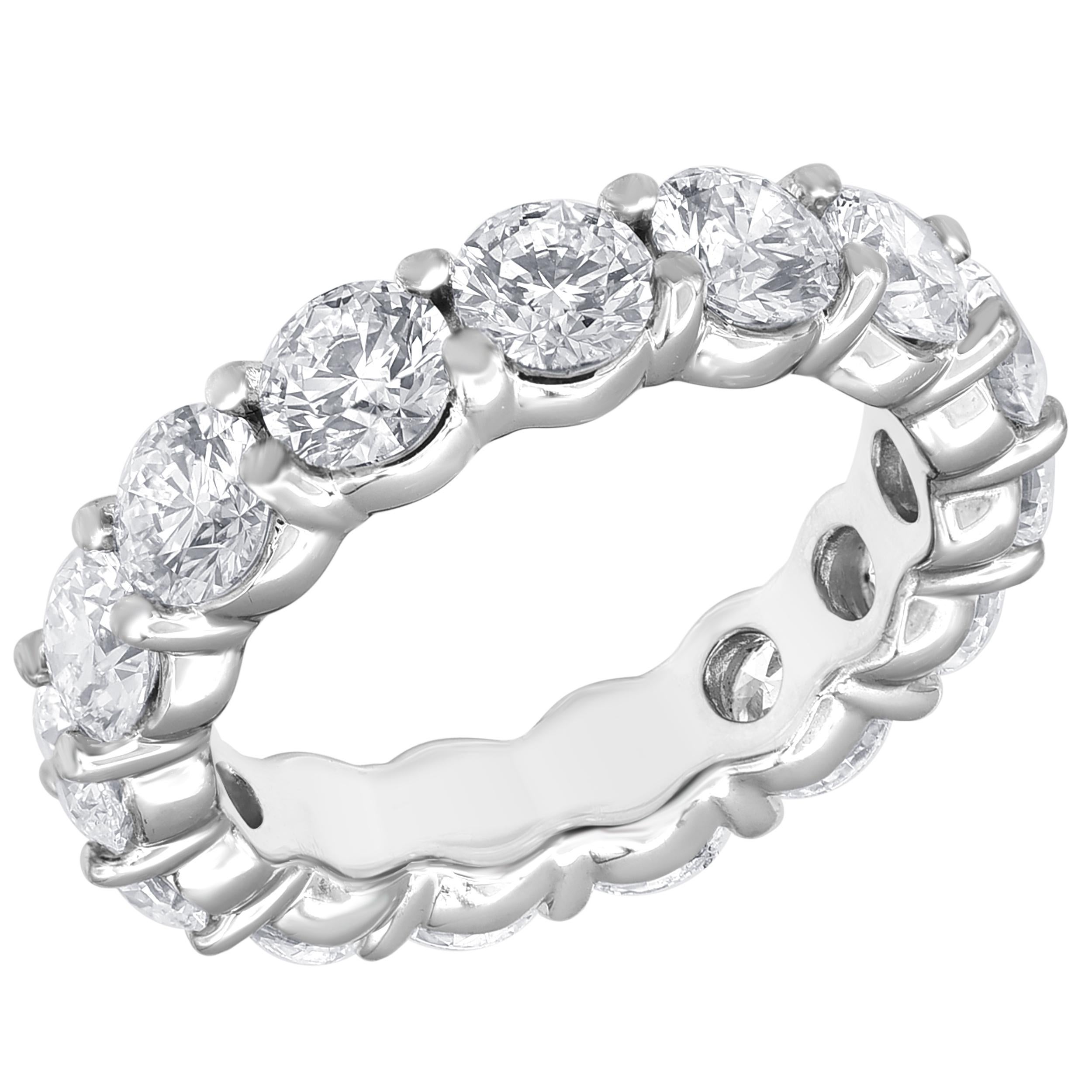 Celebrate your everlasting love story with a diamond eternity band. Stunning as a wedding or anniversary band, Fashioned in sleek and elegant Platinum, glistening round prong-set diamonds totaling 5 cts. with F-VS quality of that completely surround