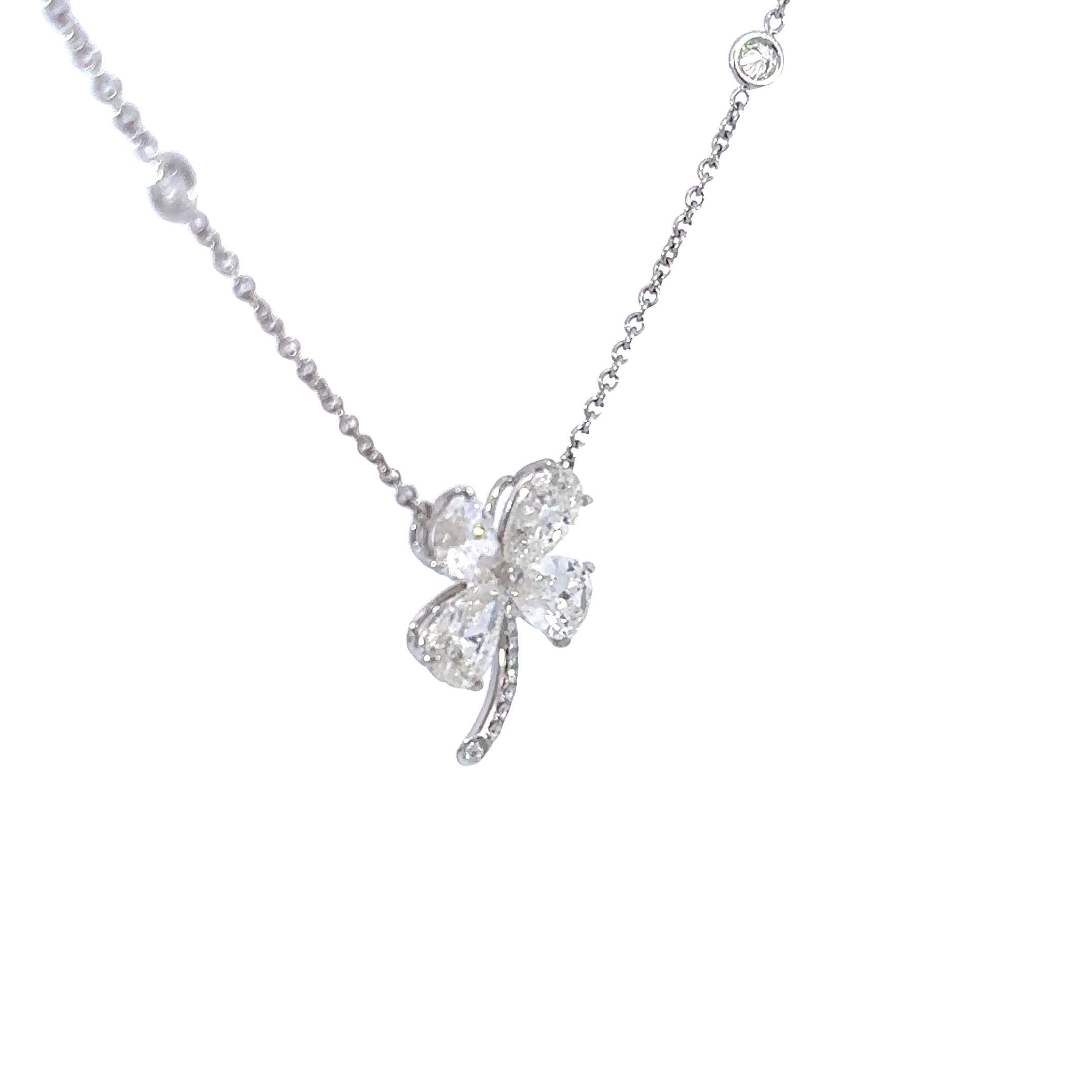 The Iris Fine Jewelry pendant necklace showcases a delicate clover design, featuring 5.0 carats of pear-cut white diamonds. The diamonds are of F color grade and VVS2 clarity, exuding brilliance and purity. Crafted in 18k white gold, this piece