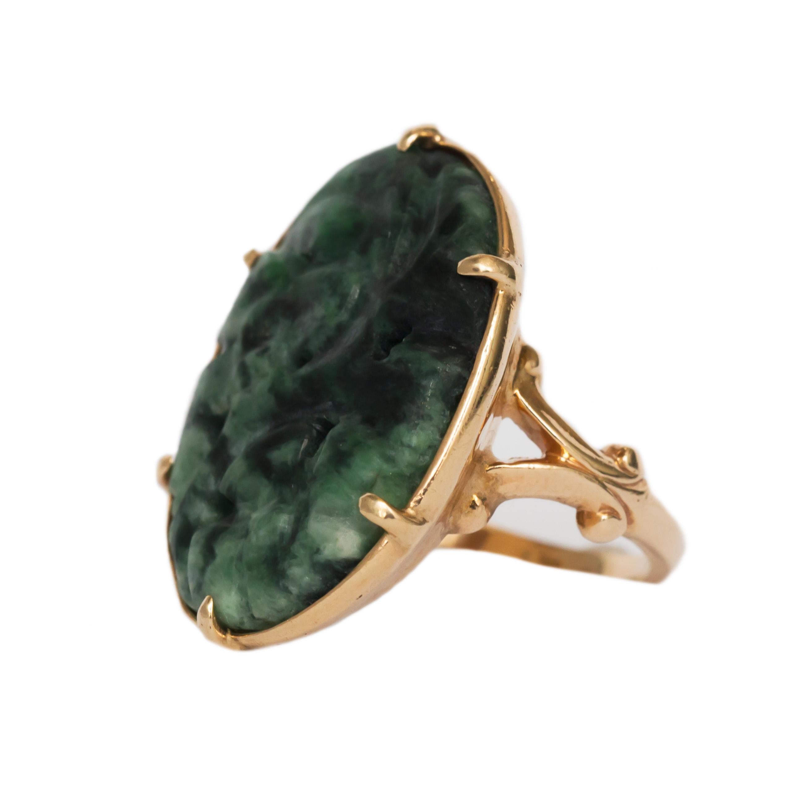 Item Details: 
Ring Size: 5.5
Metal Type: 14 karat Yellow Gold 
Weight: 7.3 grams

Center Details
Type: Natural Jade 
Shape: Carved Oval
Carat Weight: 5.00 carat
Color: Green

Finger to Top of Stone Measurement: 4.01mm