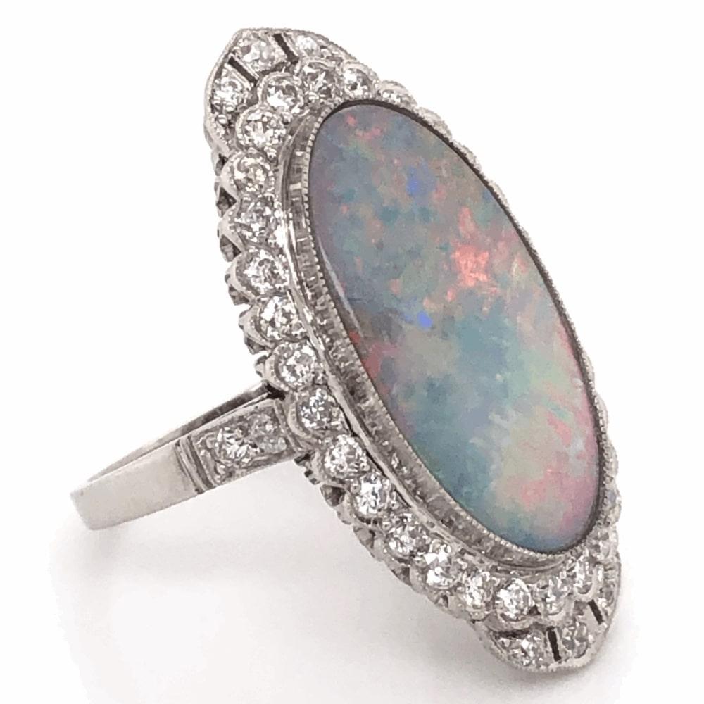 Beautiful, Elegant & finely detailed Fabulous ‘60s Platinum Ring featuring a 5 Carat oval shaped Opal securely nestled in center; surrounded by Diamonds weighing approx. 1.07 total carat weight. Hand crafted in Platinum. The ring is a size 7, we