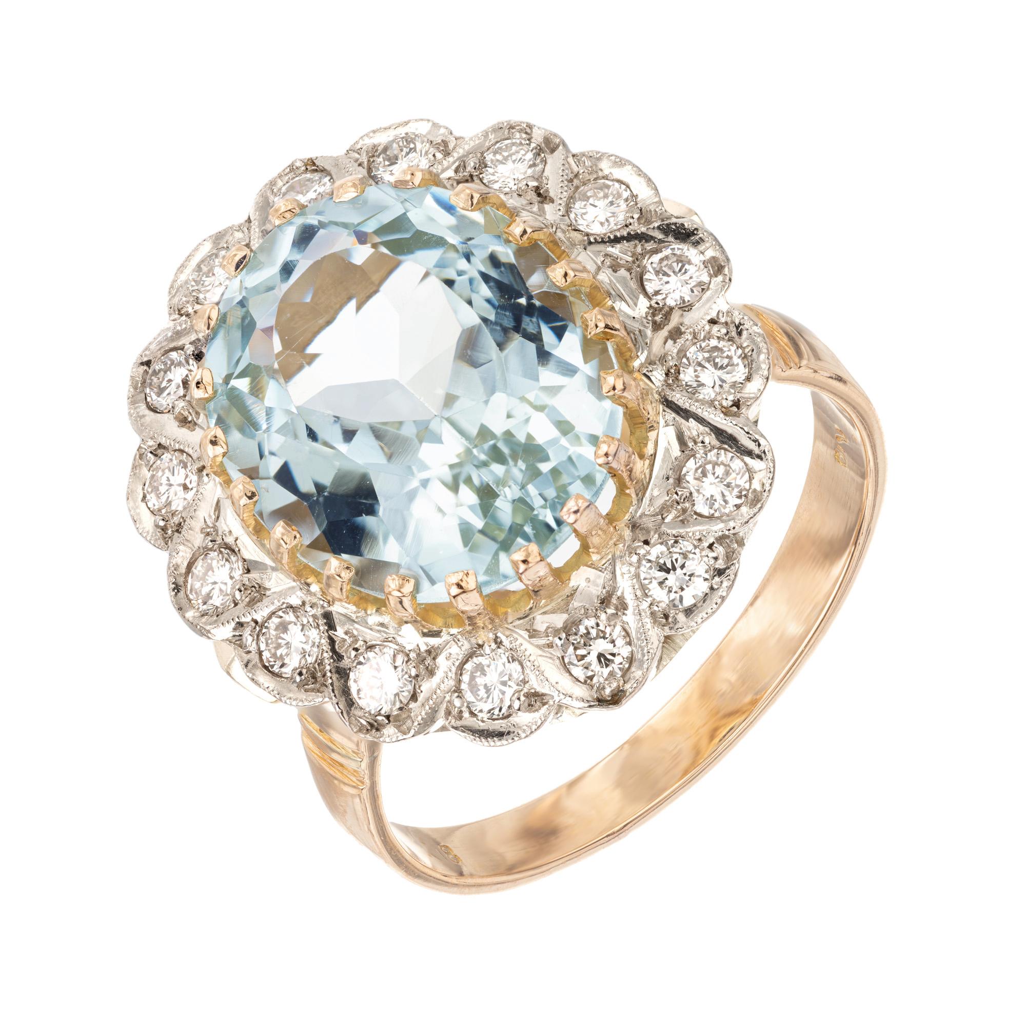 Crafted to captivate, this 1950's aquamarine and diamond tri tone gold cocktail ring is a true showstopper. 5.00 carat aqua is mounted in a 18k yellow, white and rose gold setting. Accented by a halo of 16 round brilliant cut dazzling diamonds. The