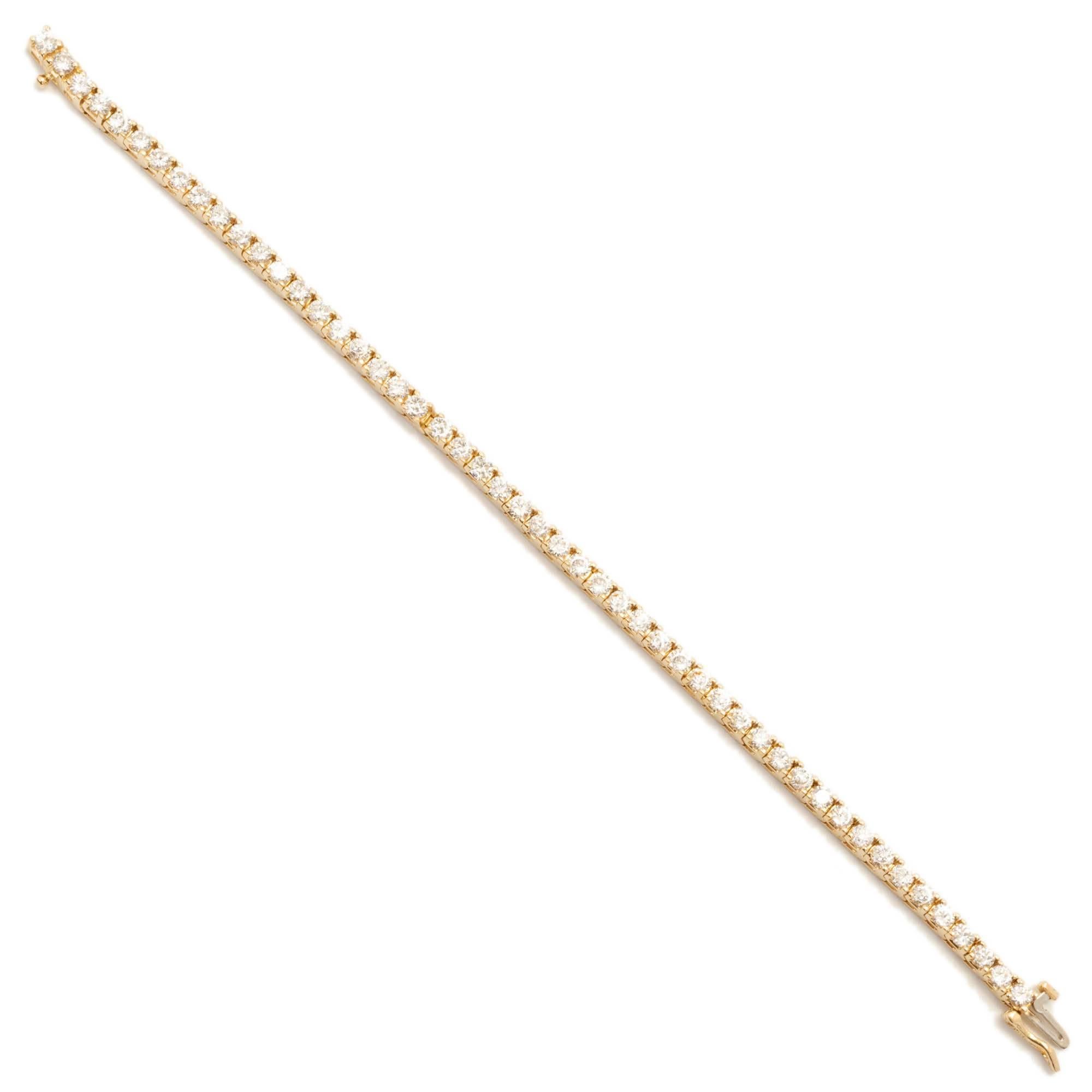 Classic solid 14k yellow gold hinged link Italian made diamond tennis bracelet with 50 bright full cut diamonds. Built in catch with side lock safety.

50 round I SI diamond 3mm Approximate 5.00 carats
14k Yellow Gold
Tested: 14k
Stamped: 14k