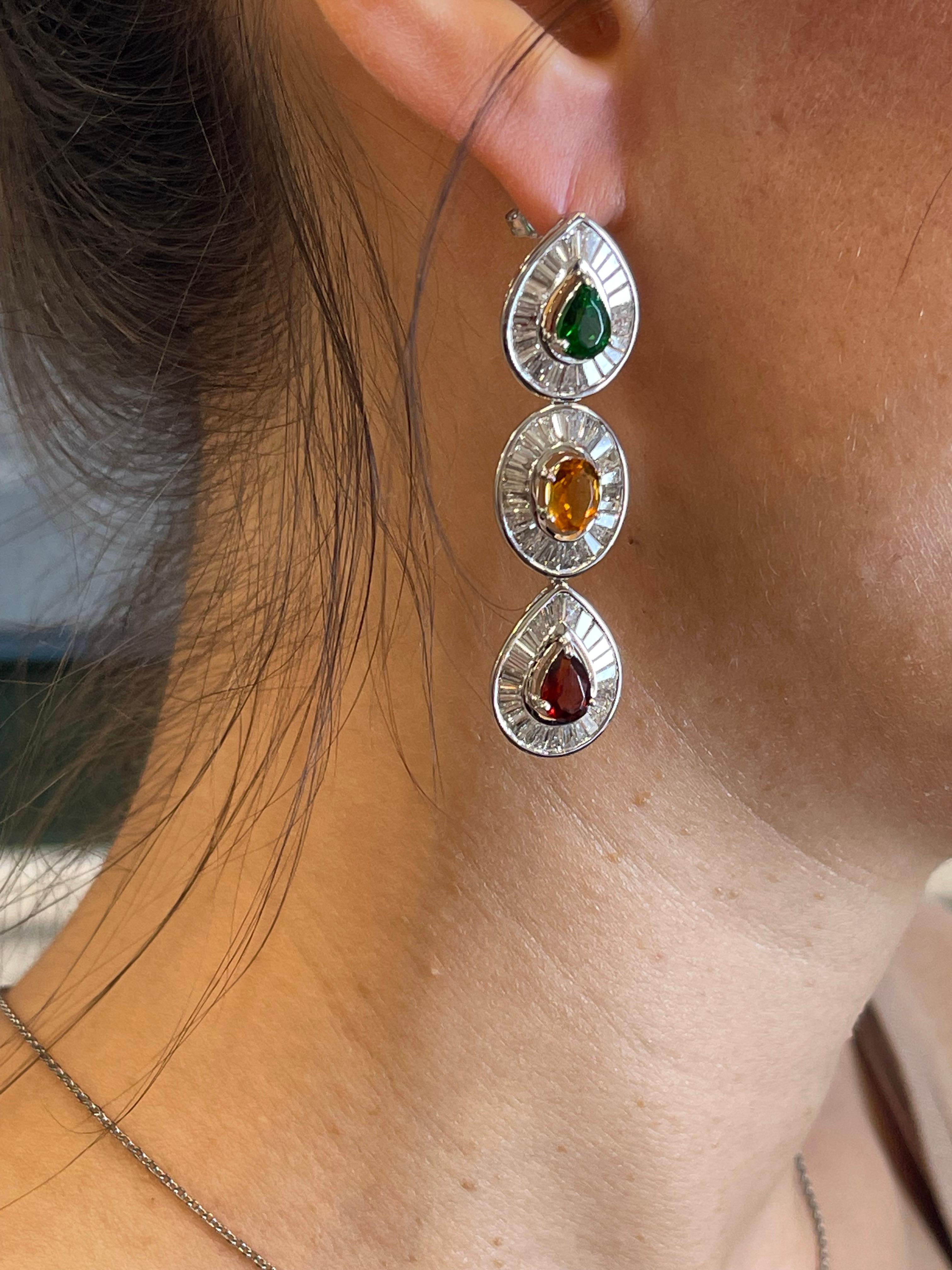 The 14k white gold setting provides a beautiful and durable base for the earrings, complementing the brilliance of the diamonds. The main diamonds, weighing 5 carats, would be quite sizable and eye-catching, adding a touch of luxury to any outfit.