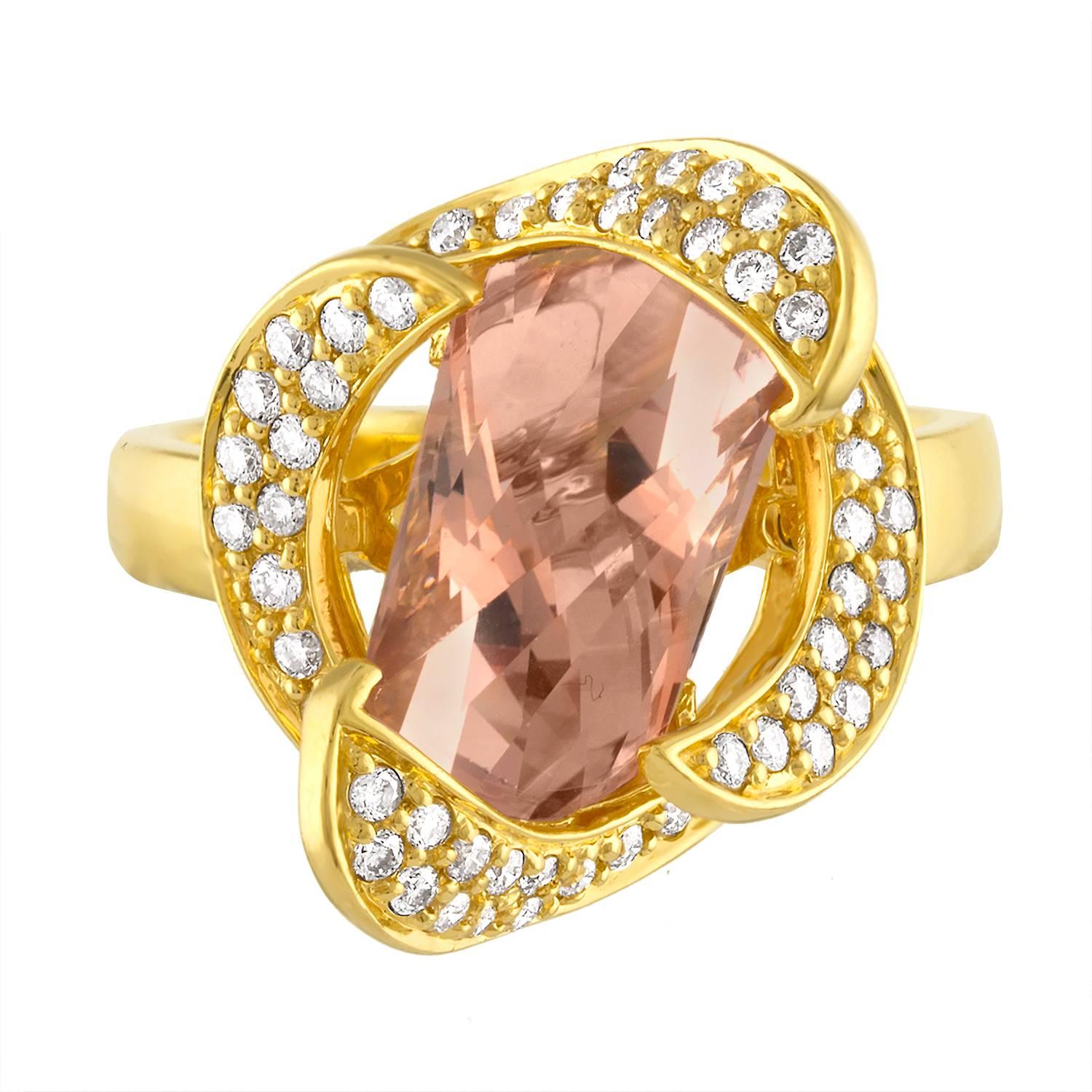 Very Unusual And Modern Design
The ring is 14K Yellow Gold
There are 0.60 Carats in Diamonds G/H SI
The Center stone is approximately 5.00 Carat Axe Cut Morganite
The ring is a size 8, sizable.
The ring weighs 8.4 grams