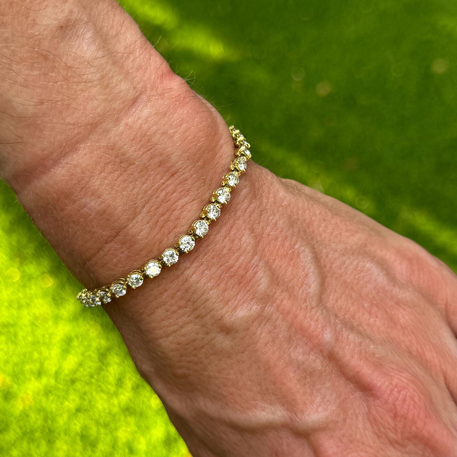 The Diamond Tennis Bracelet is a striking piece of jewelry that radiates elegance and luxury. It features 5.00 carats of round brilliant-cut diamonds, each expertly set in a sleek and polished 18-karat yellow gold setting. The 35 round brilliant cut