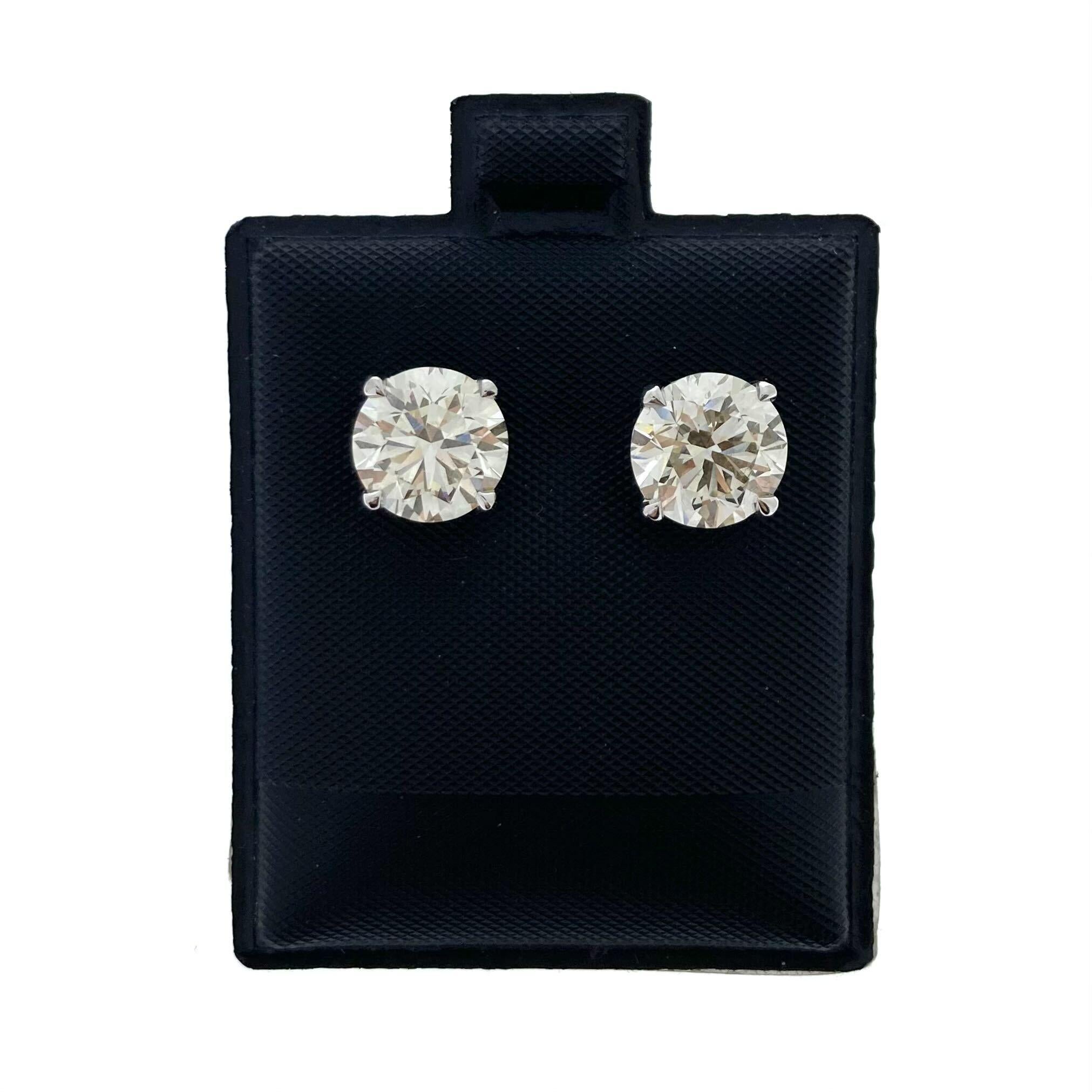 Embrace the epitome of luxury with these breathtaking 5.00 Total Carat Weight EGL Certified Round Diamond Studs in 14k White Gold. Each stud showcases a magnificent round diamond with a captivating J color grade, radiating warmth and sophistication.