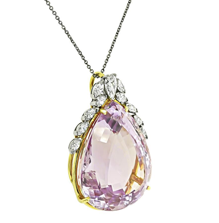 This is an amazing 14k yellow and white gold pendant. The pendant is centered with a lovely pear shape kunzite that weighs approximately 50.00ct. The center stone is accentuated by sparkling pear and marquise cut diamonds that weigh approximately