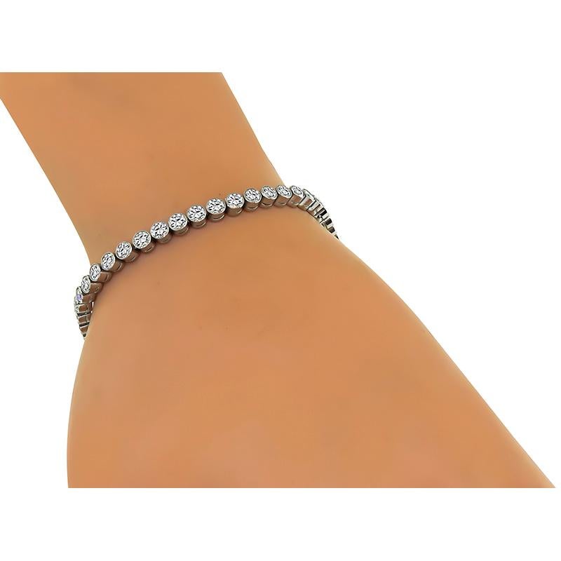 This is an elegant platinum tennis bracelet. The bracelet is set with sparkling round cut diamonds that weigh approximately 5.00ct. The color of these diamonds is G-I with VS1-SI1 clarity. The bracelet measures 7 1/4 inches in length and 3.5mm in