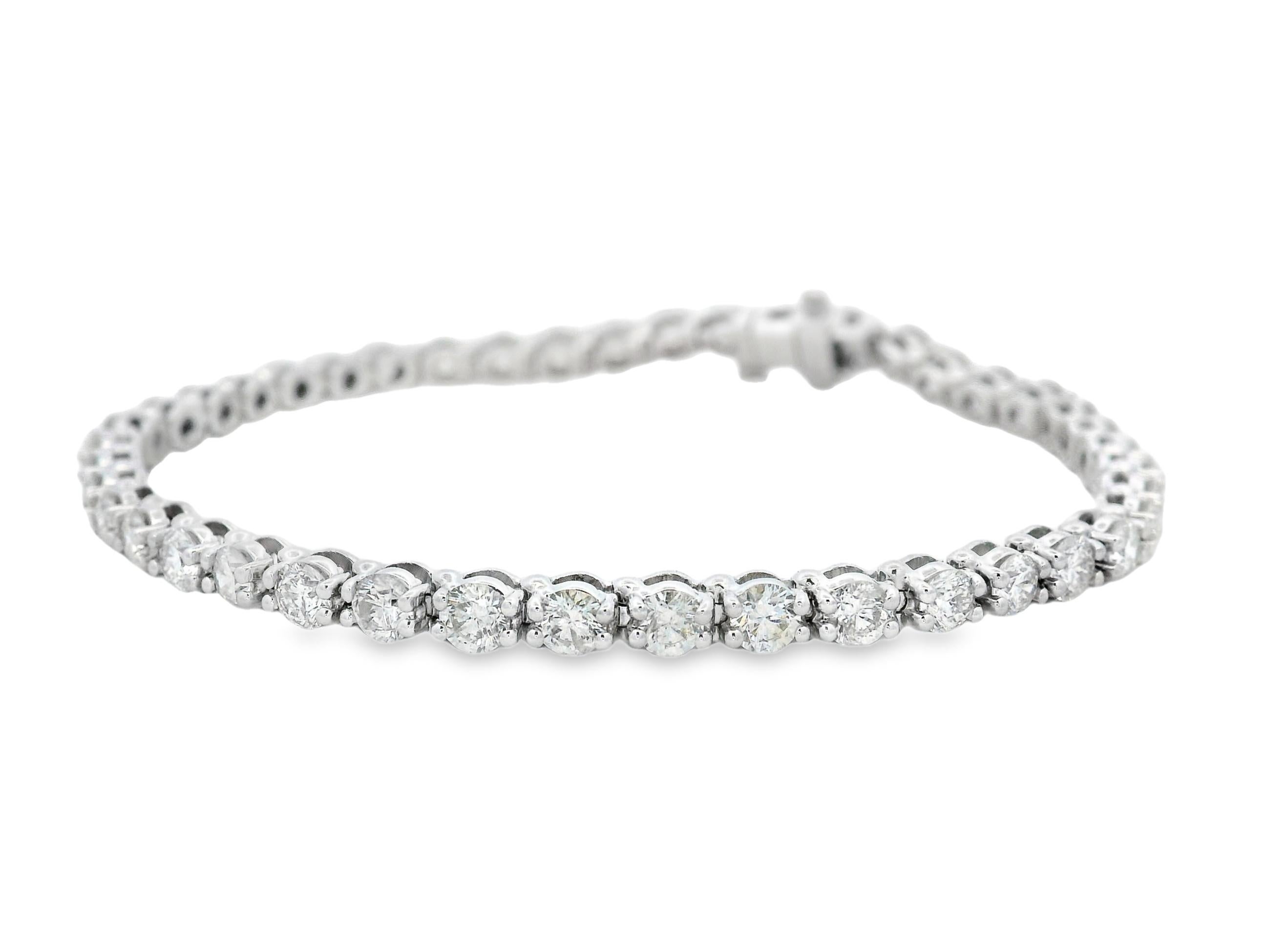 Símbolo clásico de elegancia perdurable, esta pulsera de tenis de oro blanco de 14 quilates presenta 43 diamantes redondos de talla brillante que suman un impresionante total de 5,00 quilates. Cada diamante está engastado expertamente con cuatro
