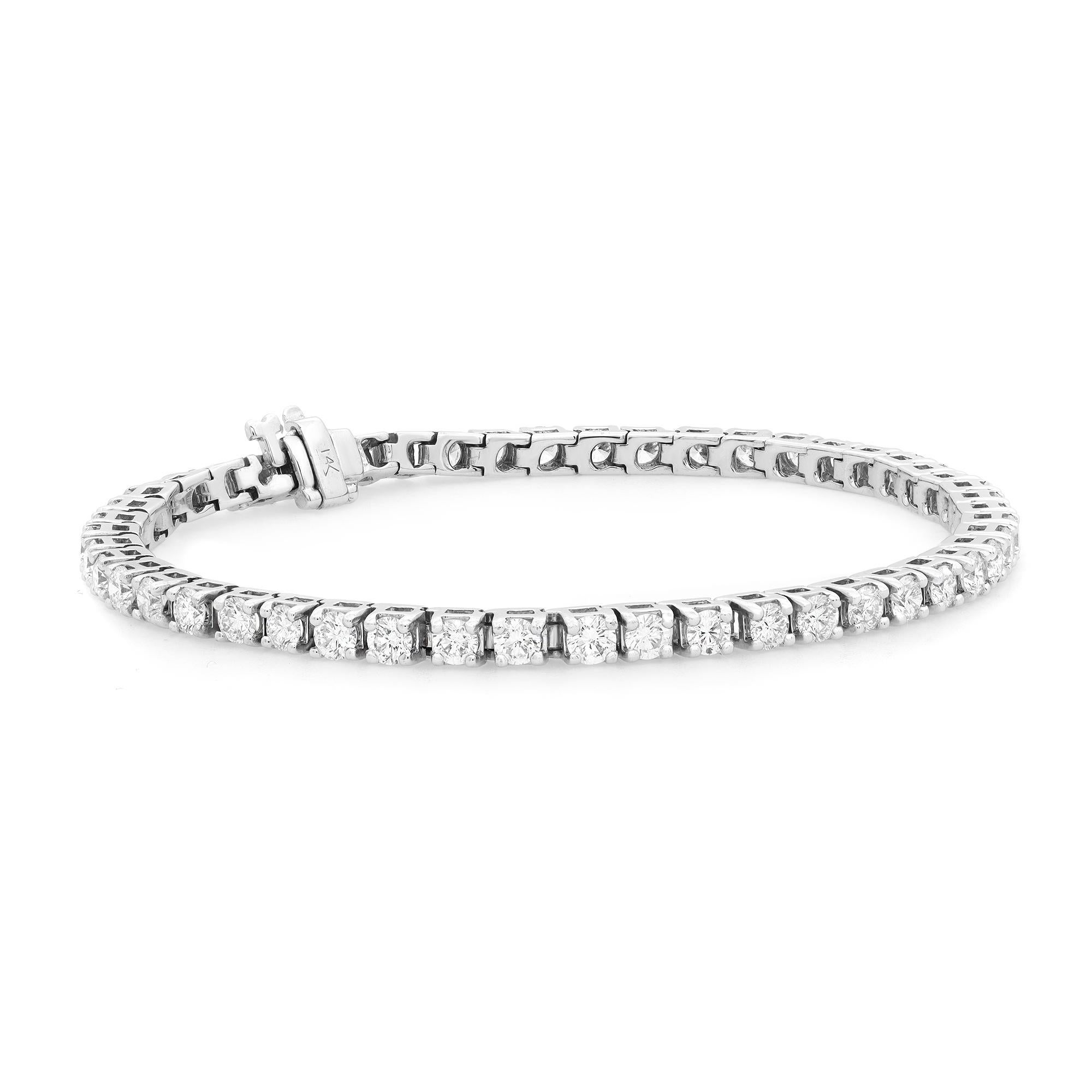Classic yet elegant, this breathtaking tennis bracelet is crafted in 14K white gold with 50 prong set dazzling round brilliant cut diamonds. Total diamond weight: 5.00 carats with each diamond size 10pt. The bright white diamonds are H color and SI