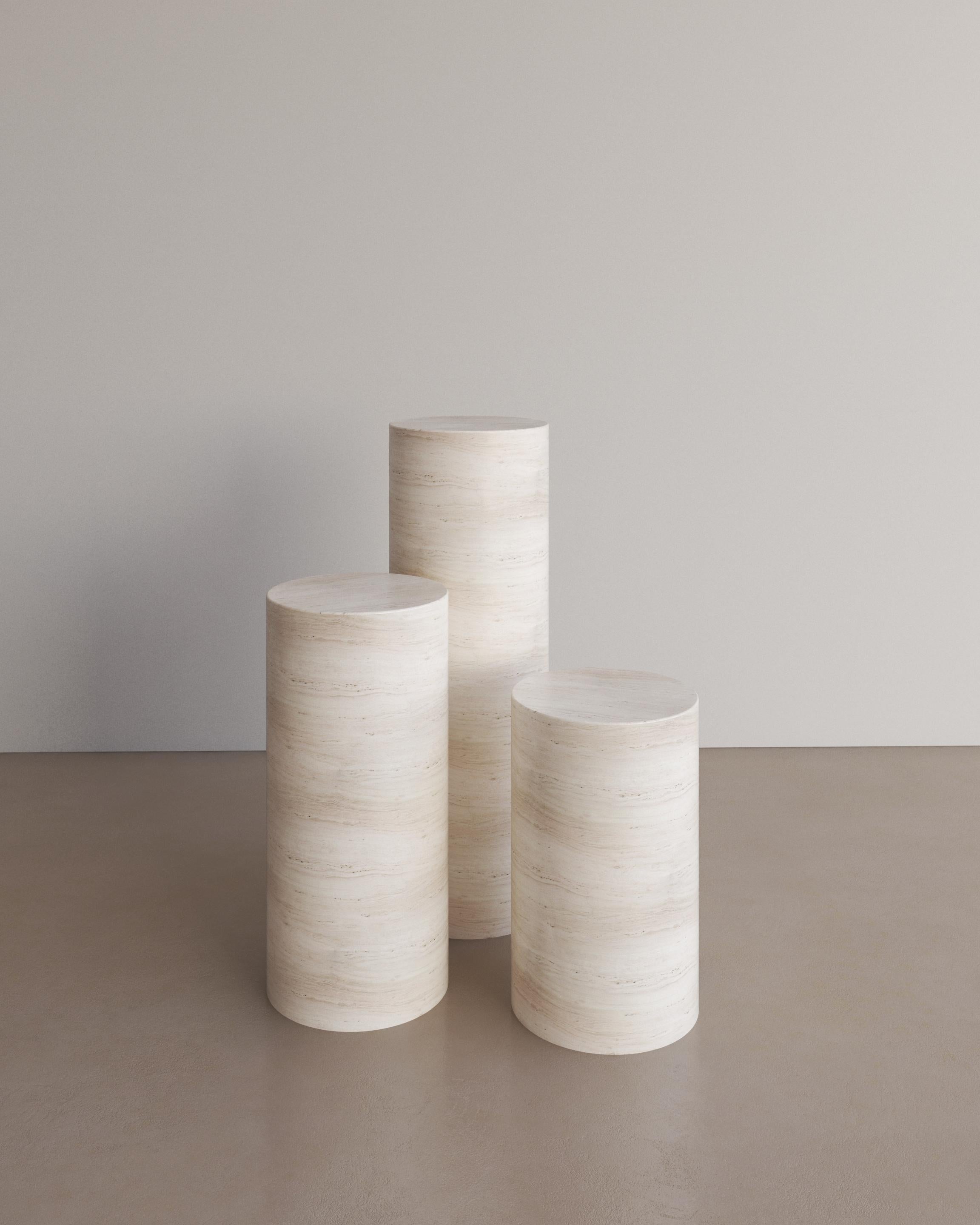 The Voyage Pedestal in Bianco Travertine by The Essentialist is envisioned as an ode to historical elegance, captured through a modern lens of minimalistic opulence. Play with scale and verticality by positioning two or three varying heights within