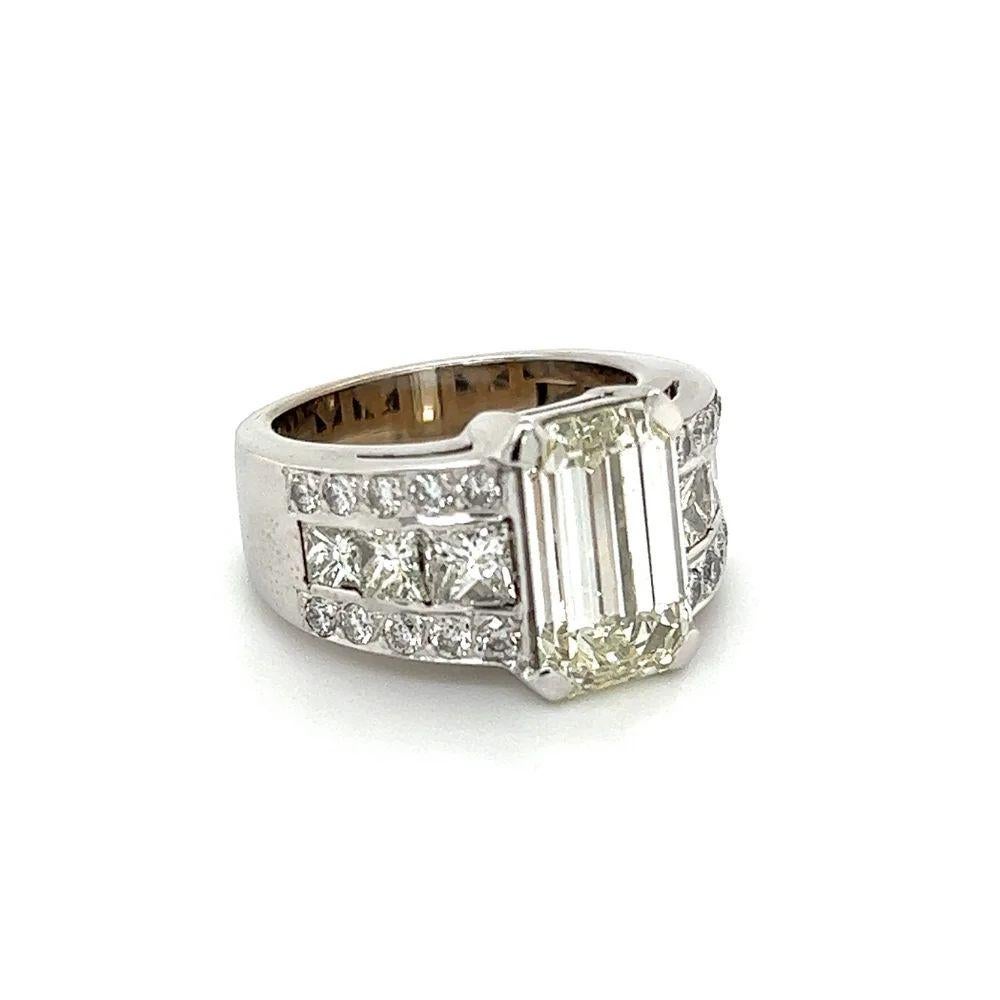 Simply Beautiful! GIA Diamond Gold Vintage Band Ring. Centering a securely Hand set GIA Emerald Diamond, weighing approx. 5.01 Carats M-VVS2. Surrounded by Princess 1.60tcw and Round Brilliant Cut Diamonds 0.45tcw; approx. 2.05tcw. GIA # 2161735521.