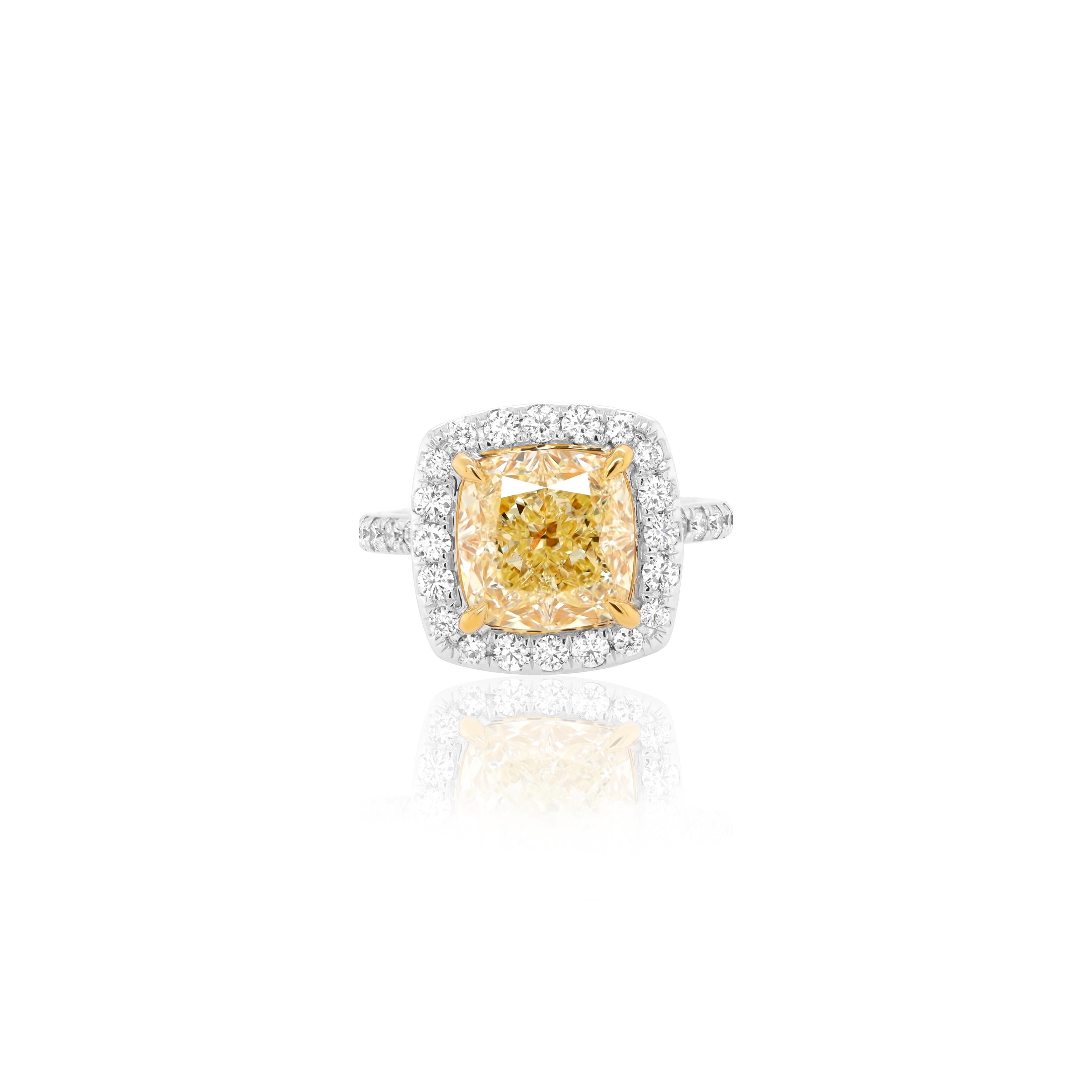 Very Classic and Elegant Canary Yellow diamond ring, with 5.01 Carat Fancy Yellow, VS1 Cushion Cut diamond, certified by GIA, set in platinum halo setting with 0.75 carats of round brilliant cut diamonds.