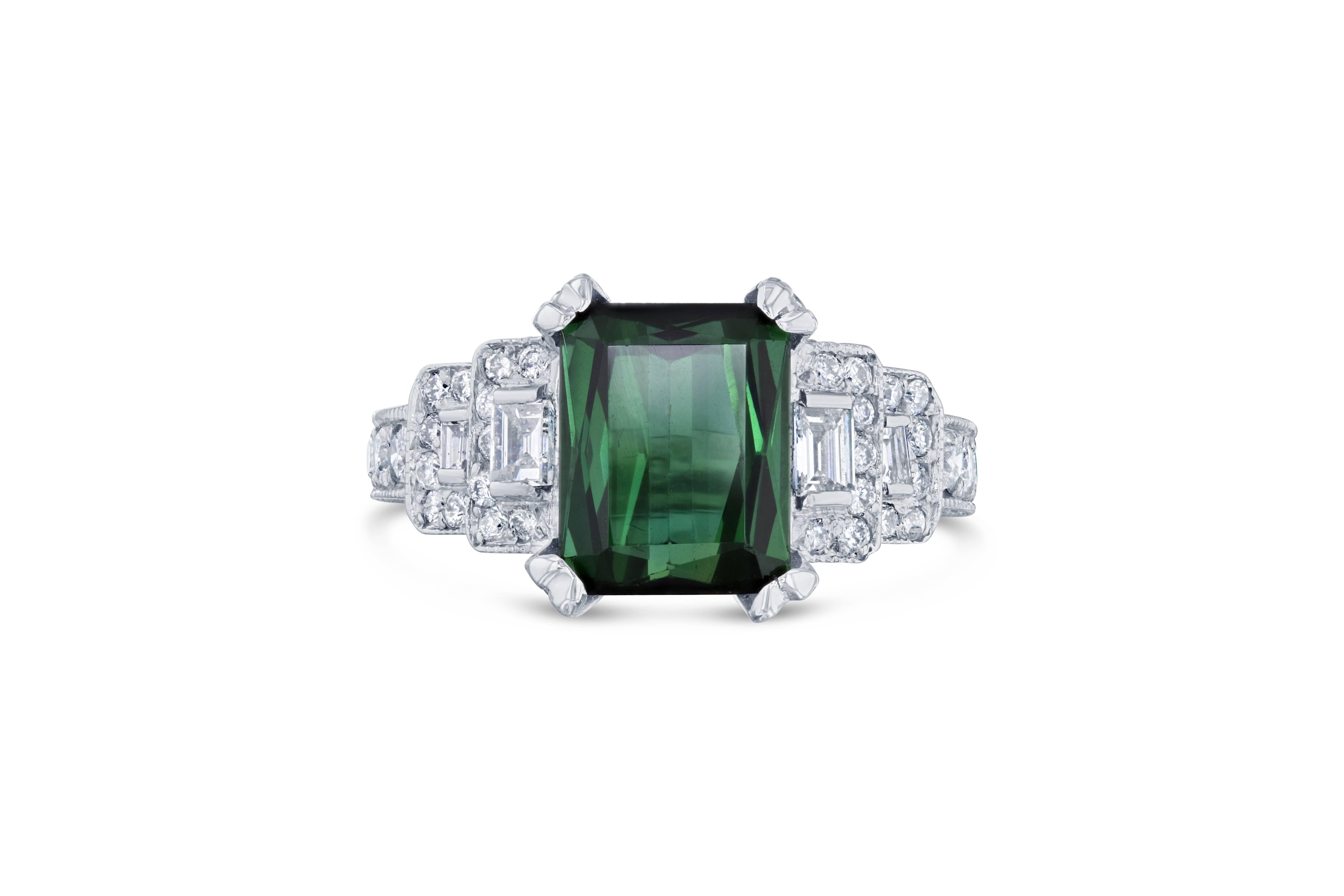 This ring has a mesmerizing Emerald cut Green Tourmaline weighing 3.71 Carats and 86 Round Cut Diamonds weighing 0.97 Carats as well as 4 Baguette Cut Diamonds weighing 0.33 Carats. The total carat weight of the ring is 5.01 Carats. 

The Emerald