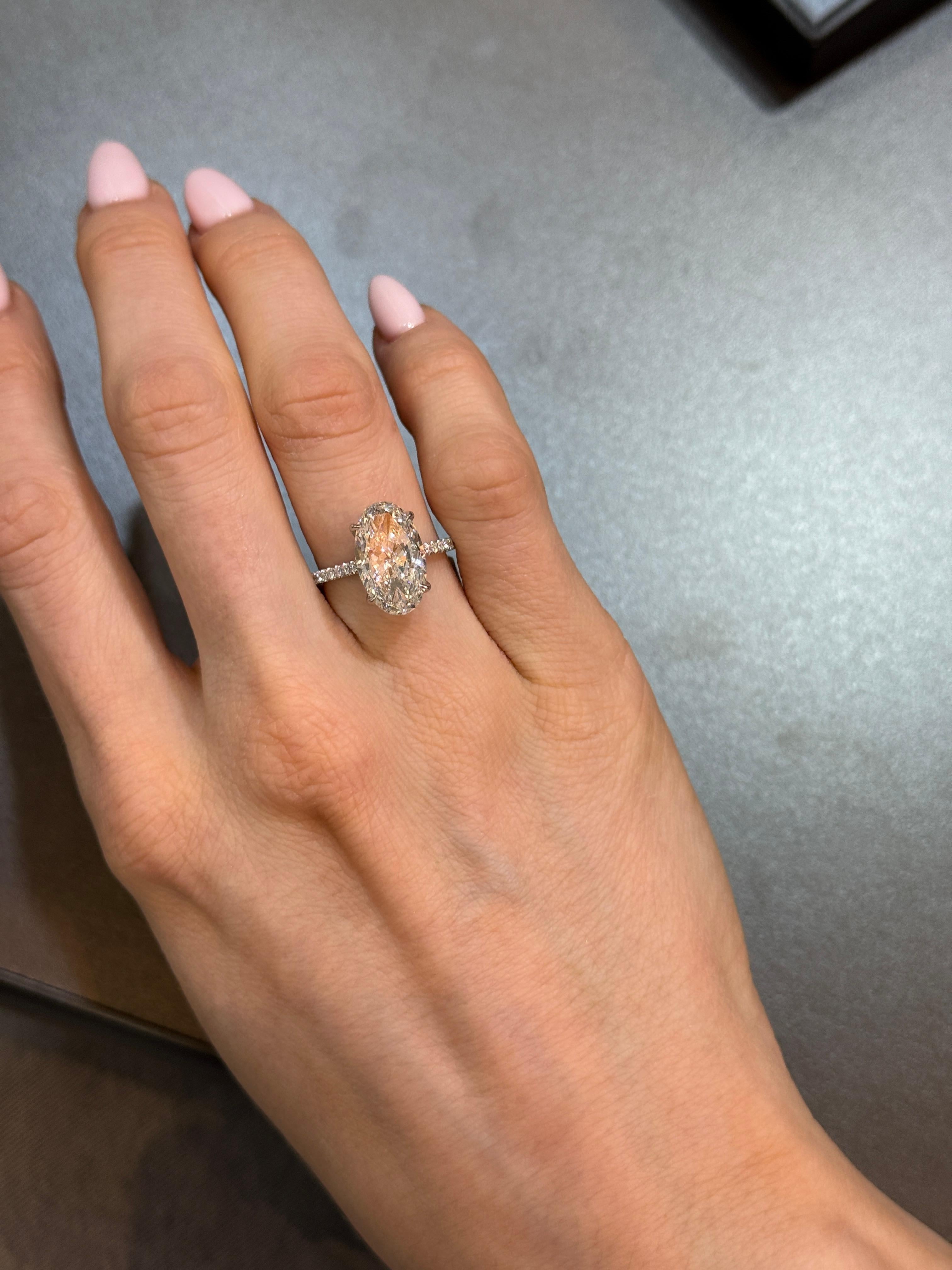 A sophisticated engagement ring featuring a 5.01ct Oval Brilliant diamond, certified by GIA. With a coveted D color and VS2 clarity, this diamond embodies rarity and timeless beauty. Expertly cut with Excellent polish and symmetry, the stone